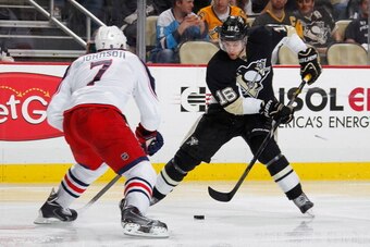 PITTSBURGH, PA - APRIL 26:  Brandon Sutter #16 of the Pittsburgh Penguins moves the puck in front of Jack Johnson #7 of the Columbus Blue Jackets in Game Five of the First Round of the 2014 Stanley Cup Playoffs at Consol Energy Center on April 26, 2014 in