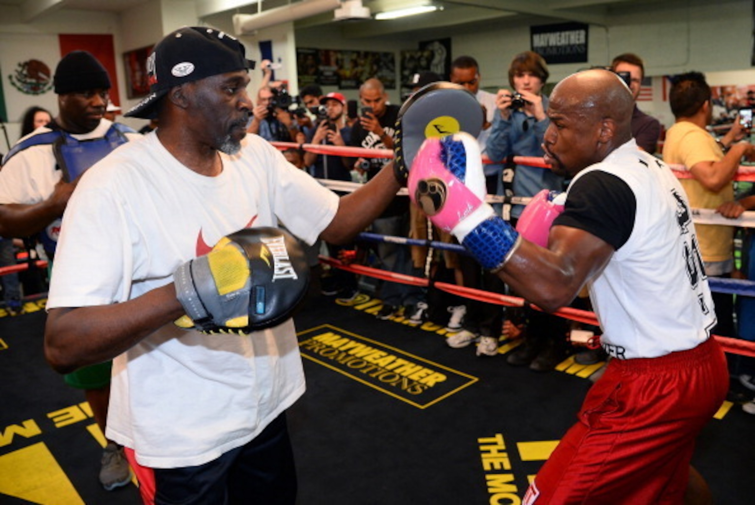 LAS VEGAS, NV - APRIL 22:  Boxer Floyd Mayweather Jr. (R) works out with his trainer and uncle Roger Mayweather at the Mayweather Boxing Club on April 22, 2014 in Las Vegas, Nevada. Mayweather will face Marcos Maidana in a 12-round world championship unif