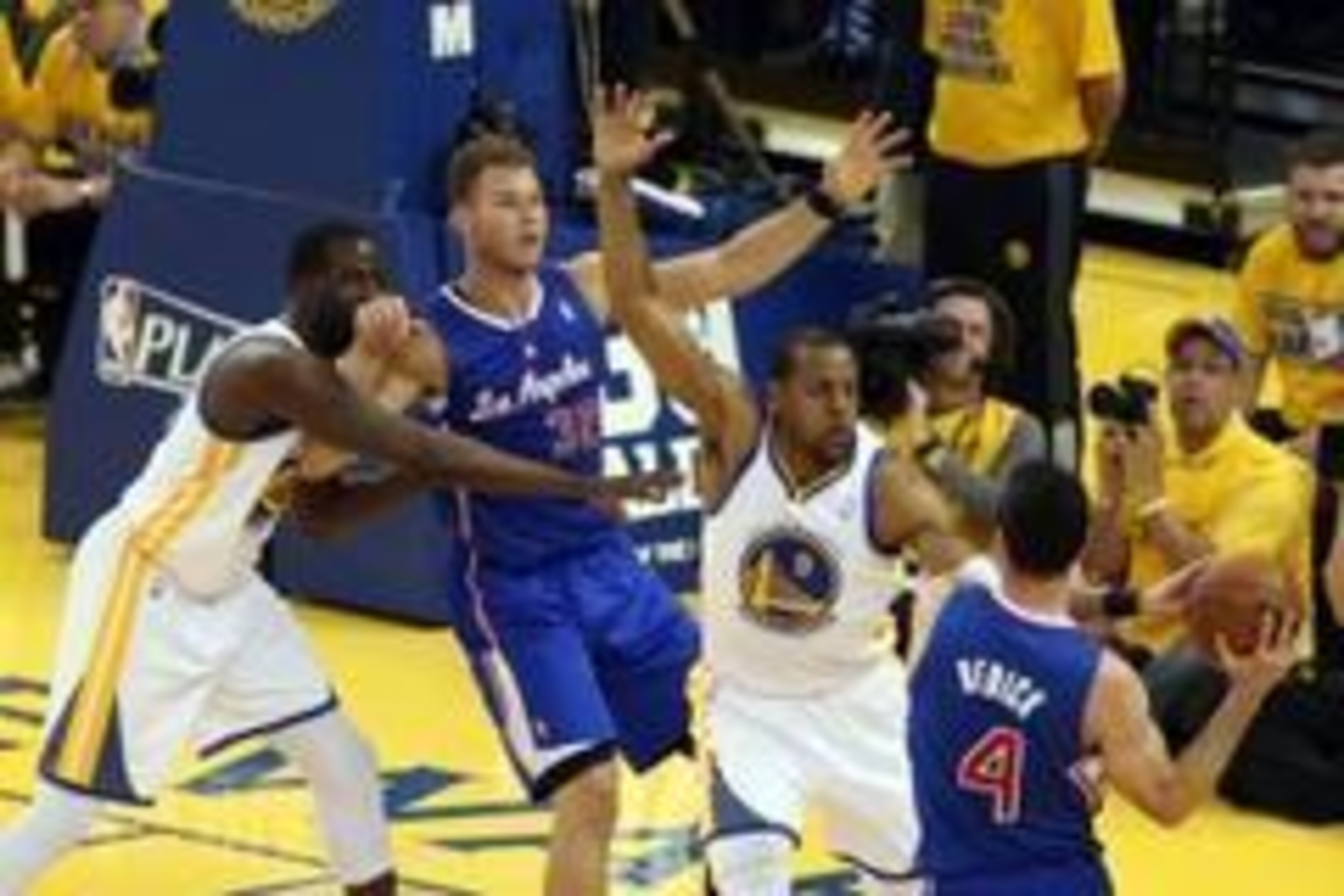 Apr 27, 2014; Oakland, CA, USA; Los Angeles Clippers guard J.J. Redick (4) looks to pass the ball to forward Blake Griffin (32) against Golden State Warriors forward Andre Iguodala (9) and forward Draymond Green (23) during the first quarter of game four 