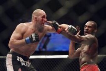Apr 26, 2014; Baltimore, MD, USA;  Jon Jones and Glover Teixeira exchange punches during the UFC light heavy weight championship fight at  Baltimore Arena. Jones retained the light heavy height championship by defeating  Teixeria.  Mandatory Credit: Tommy