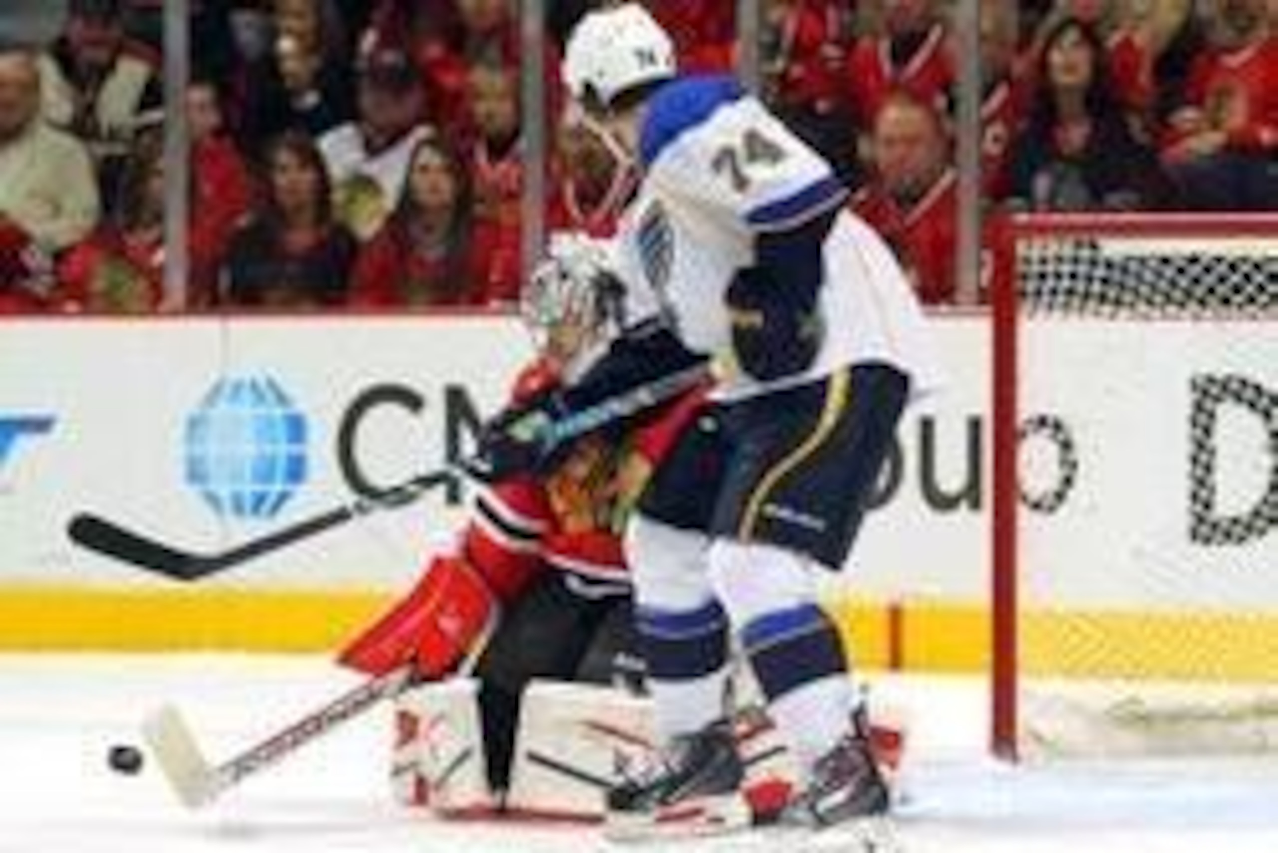 Apr 27, 2014; Chicago, IL, USA; Chicago Blackhawks goalie Corey Crawford (50) makes a save on a tip attempt by St. Louis Blues right wing T.J. Oshie (74) during the second period in game six of the first round of the 2014 Stanley Cup Playoffs at the Unite