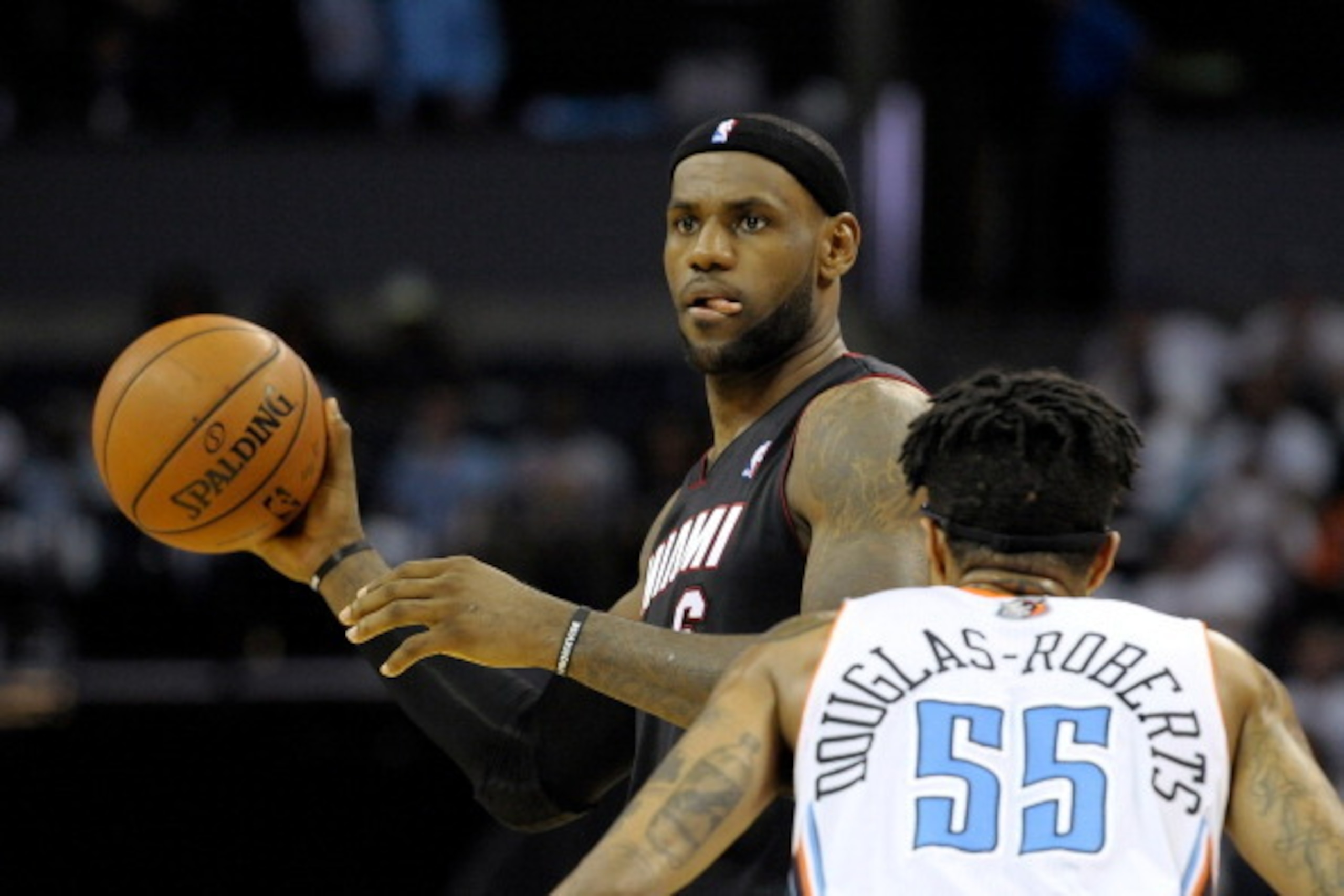CHARLOTTE, NC - APRIL 26:  Chris Douglas-Roberts #55 of the Charlotte Bobcats defends LeBron James #6 of the Miami Heat in Game Three of the Eastern Conference Quarterfinals during the 2014 NBA Playoffs at Time Warner Cable Arena on April 26, 2014 in Char