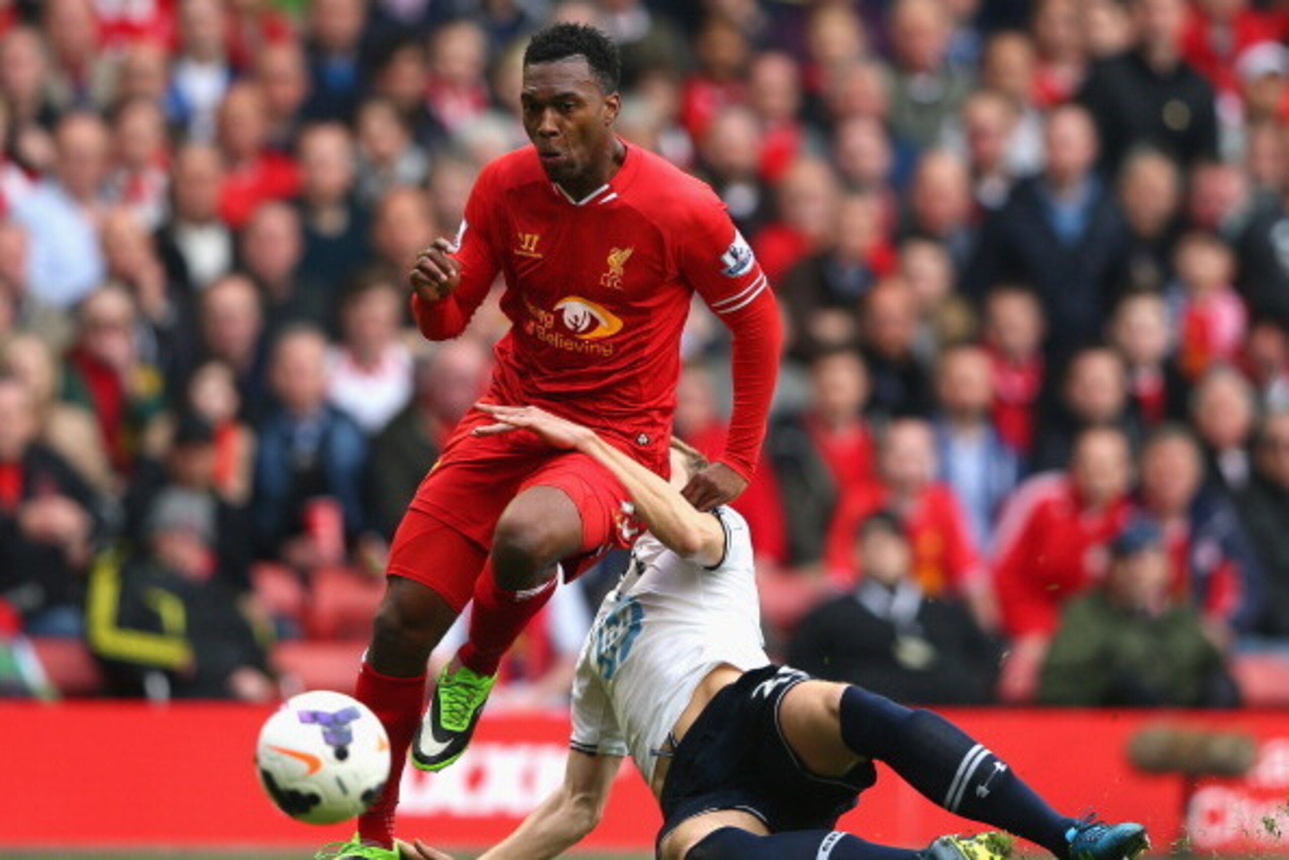 LIVERPOOL, ENGLAND - MARCH 30:  Daniel Sturridge of Liverpool is challenged by Michael Dawson of Tottenham Hotspur during the Barclays Premier League match between Liverpool and Tottenham Hotspur at Anfield on March 30, 2014 in Liverpool, England.  (Photo