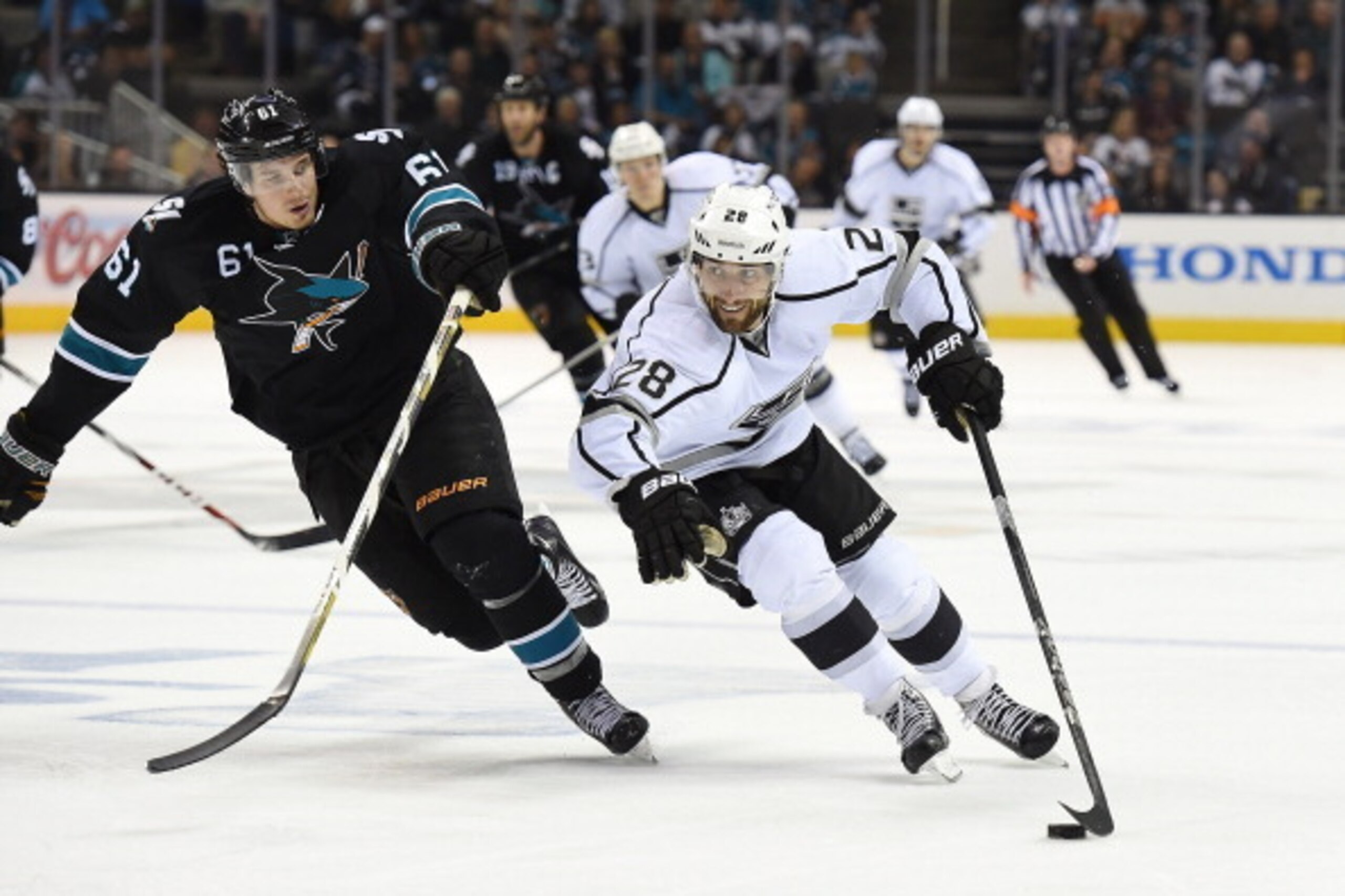 SAN JOSE, CA - APRIL 26:  Jarret Stoll #28 of the Los Angeles King skates with control of the puck keeping it away from Justin Braun #61 of the San Jose Sharks in the third period in Game Five of the First Round of the 2014 NHL Stanley Cup Playoffs at SAP