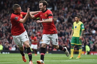 MANCHESTER, ENGLAND - APRIL 26:  Juan Mata of Manchester United celebrates scoring the third goal with Tom Cleverley during the Barclays Premier League match between Manchester United and Norwich City at Old Trafford on April 26, 2014 in Manchester, Engla