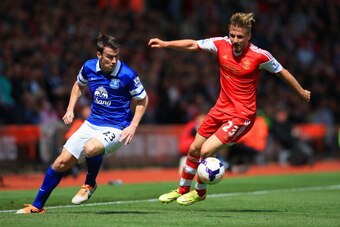 SOUTHAMPTON, ENGLAND - APRIL 26: Luke Shaw of Southampton is marshalled by Seamus Coleman of Everton  during the Barclays Premier League match between Southampton and Everton at St Mary's Stadium on April 26, 2014 in Southampton, England.  (Photo by Richa