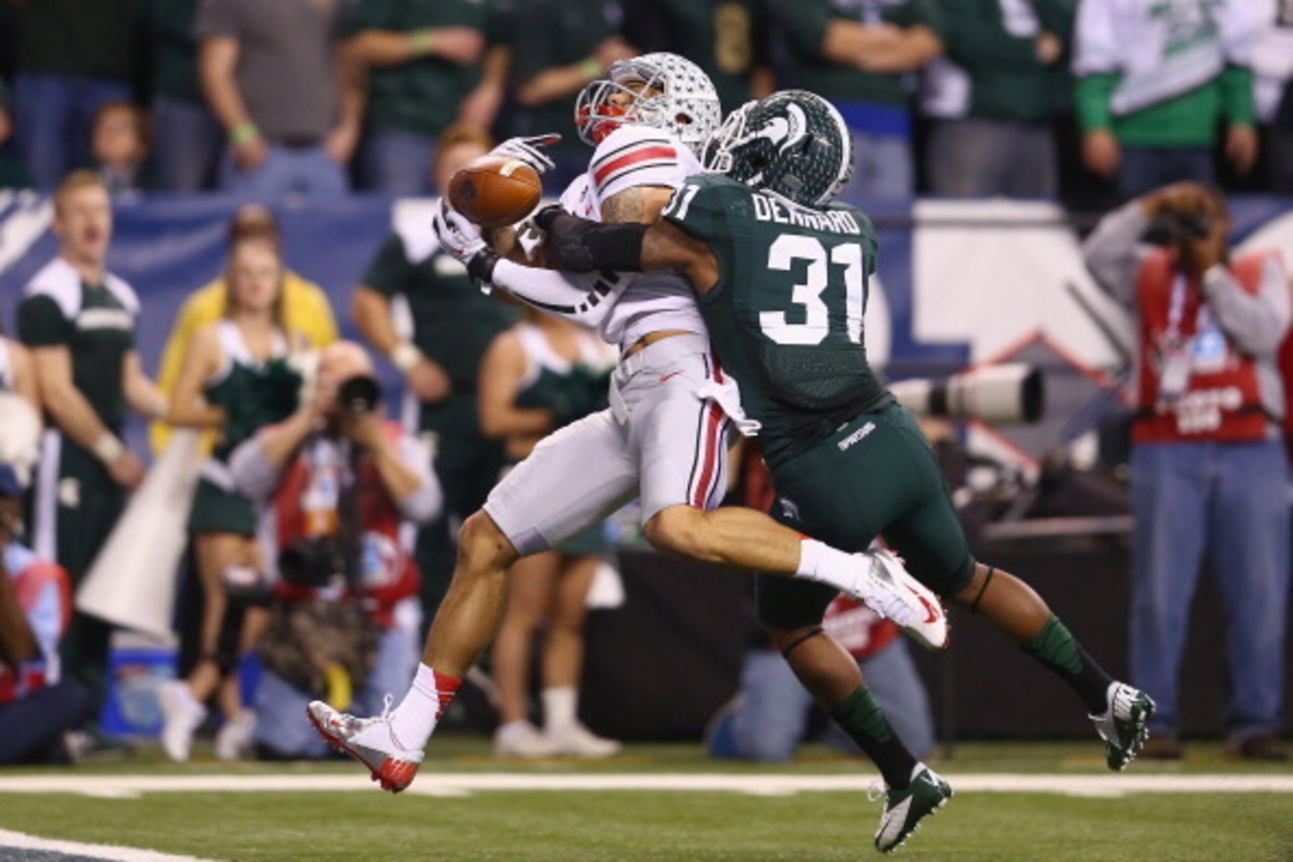 INDIANAPOLIS, IN - DECEMBER 07:  Darqueze Dennard #31 of the Michigan State Spartans breaks up a pass to Devin Smith #9 of the Ohio State Buckeyes during the Big Ten Conference Championship game at Lucas Oil Stadium on December 7, 2013 in Indianapolis, In