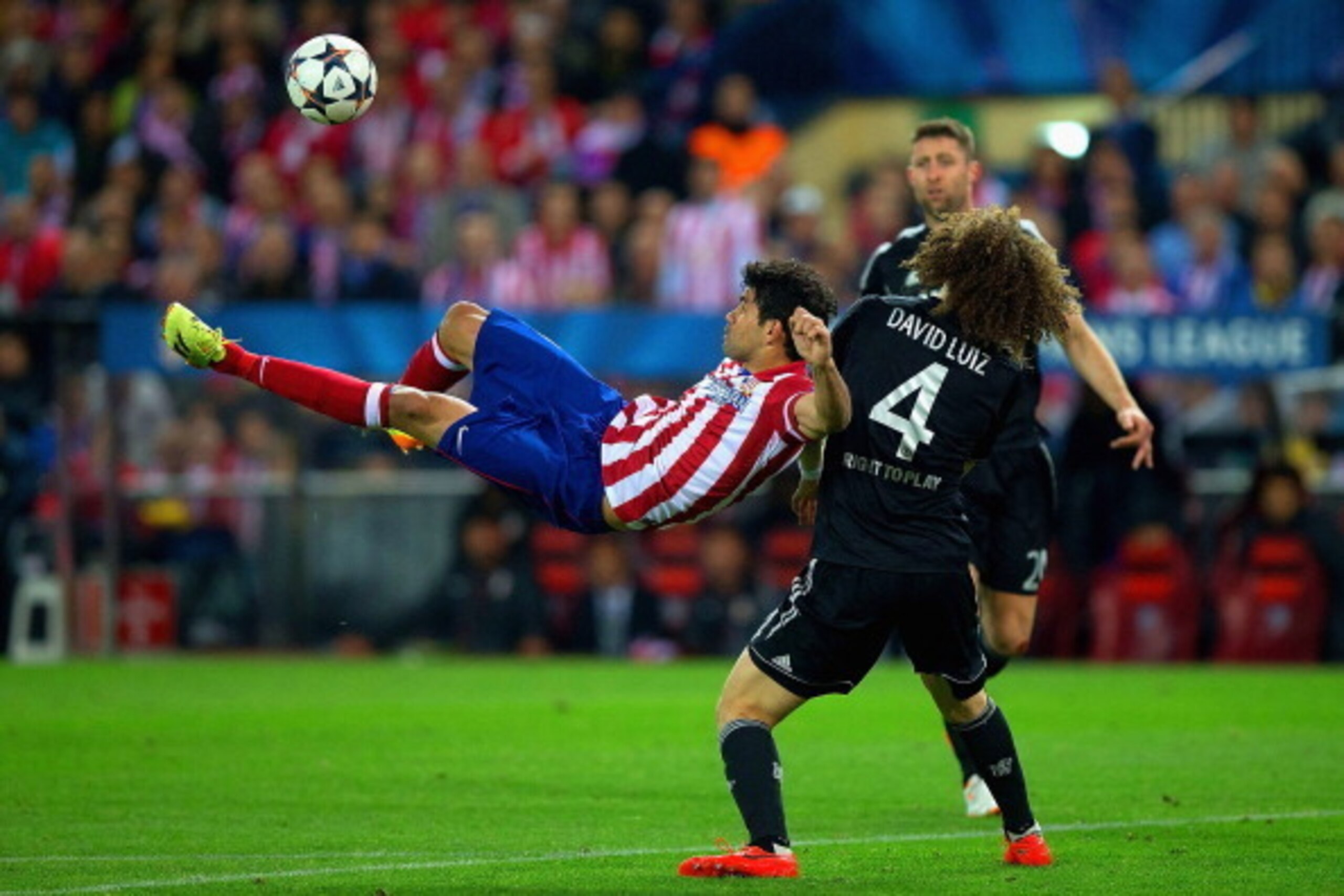 MADRID, SPAIN - APRIL 22:  Diego Costa of Club Atletico de Madrid kicks the ball under pressure from David Luiz of Chelsea during the UEFA Champions League Semi Final first leg match between Club Atletico de Madrid and Chelsea at Vicente Calderon Stadium 