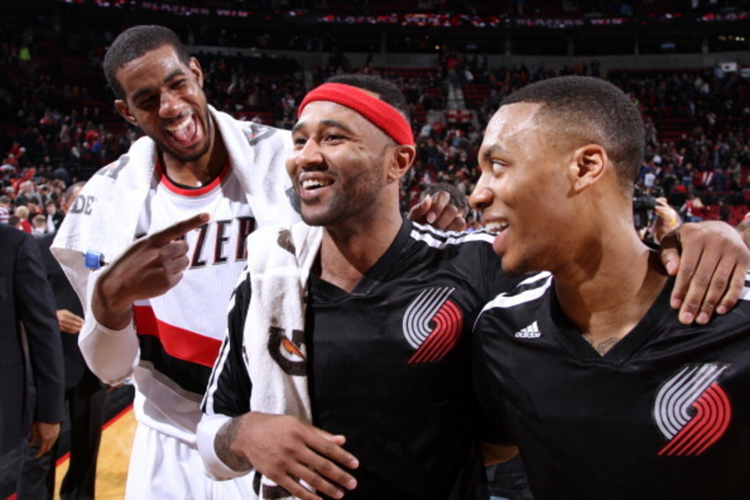 PORTLAND, OR - JANUARY 15:  LaMarcus Aldridge #12, Mo Williams #25 and Damian Lillard #0 of the Portland Trail Blazers smile and laugh after the game against the Cleveland Cavaliers on January 15, 2014 at the Moda Center Arena in Portland, Oregon. NOTE TO