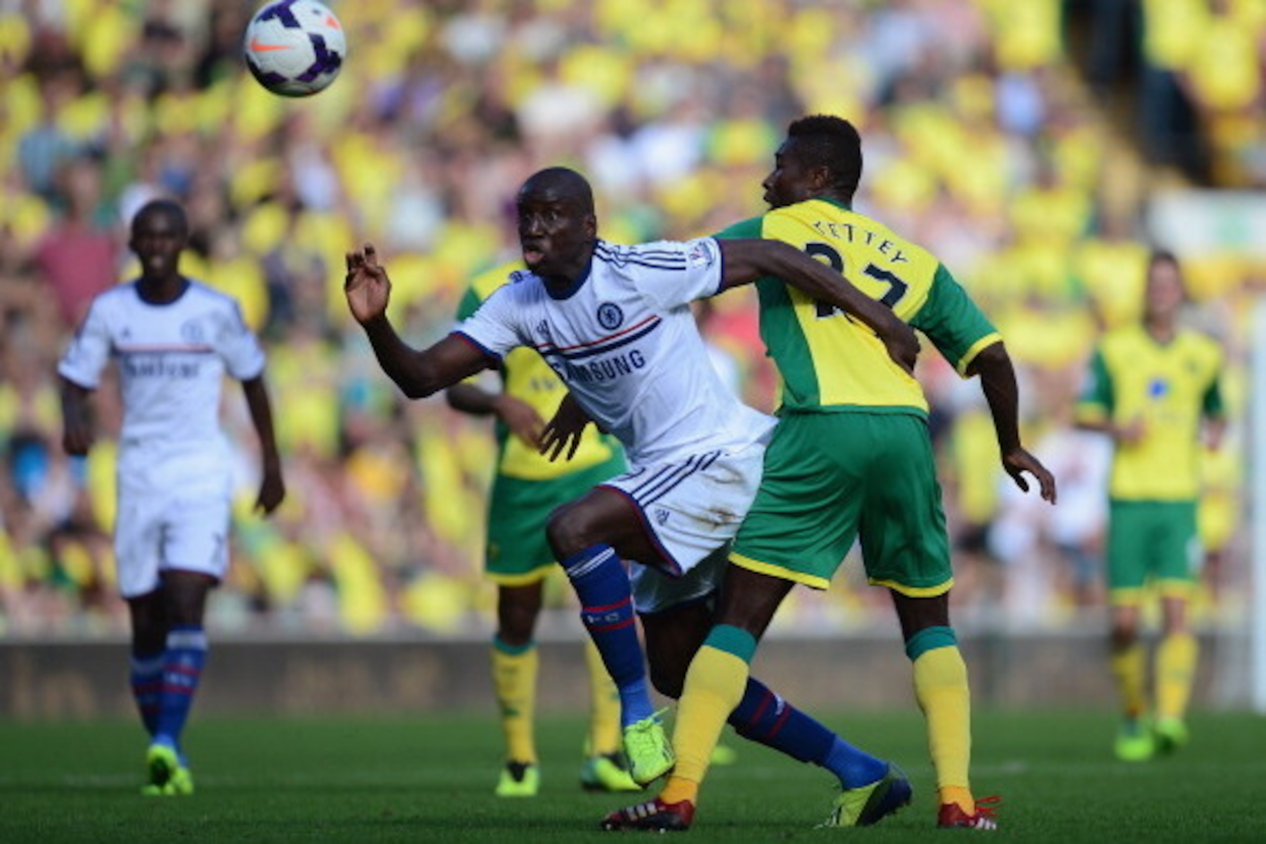 NORWICH, ENGLAND - OCTOBER 06: Demba Ba of Chelsea and Alexander Tettey of Norwich City battle for the ball during the Barclays Premier League match between Norwich City and Chelsea at Carrow Road on October 6, 2013 in Norwich, England. (Photo by Jamie NORWICH, ENGLAND - OCTOBER 06: Demba Ba of Chelsea and Alexander Tettey of Norwich City battle for the ball during the Barclays Premier League match between Norwich City and Chelsea at Carrow Road on October 6, 2013 in Norwich, England. (Photo by Jamie