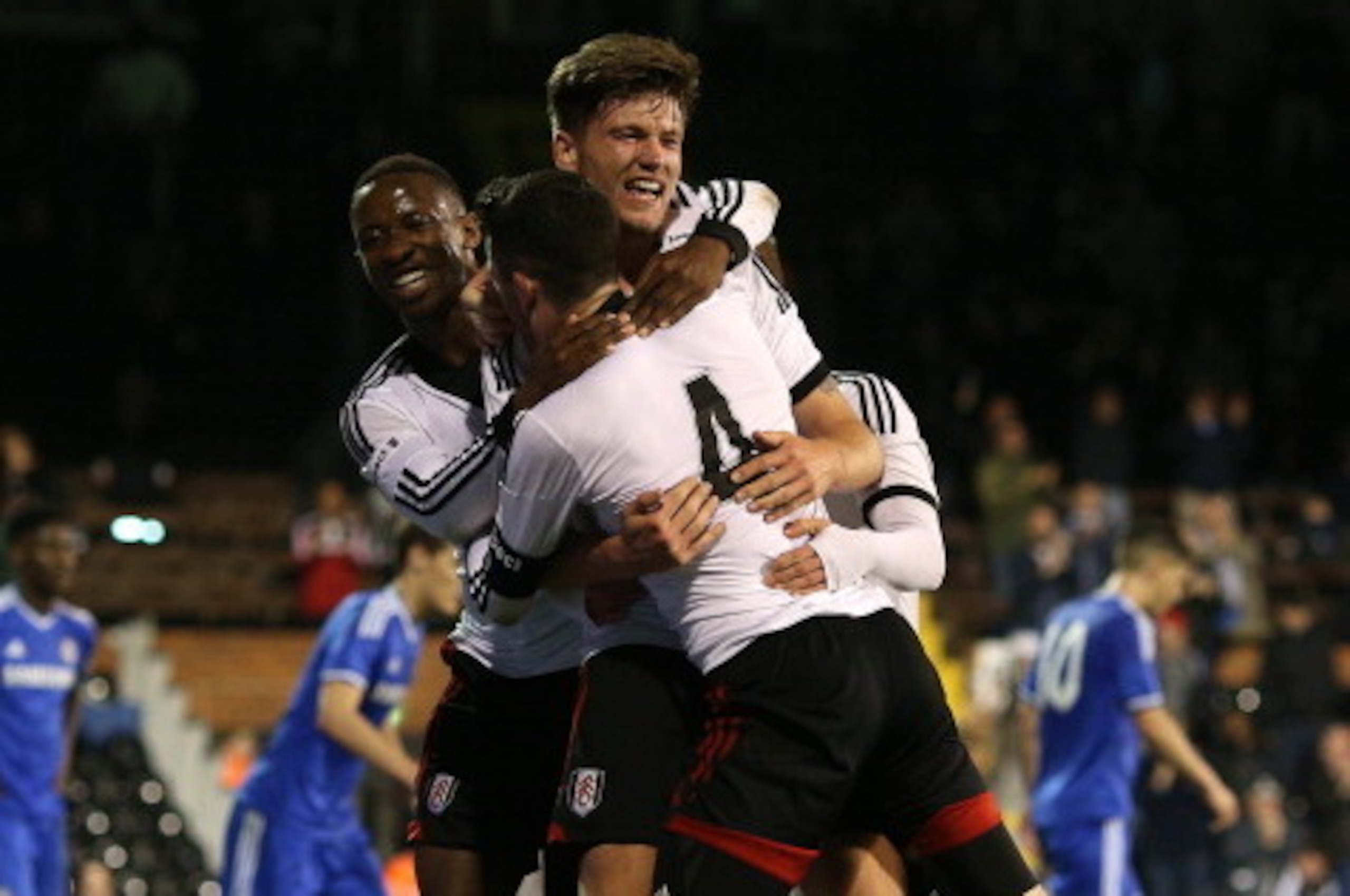 LONDON, ENGLAND - APRIL 28: Cameron Burgess of Fulham (C) celebrates with team mates after scoring the teams third goal during the FA Youth Cup Final: First Leg match between Fulham and Chelsea at Craven Cottage on April 28, 2014 in London, England. (Phot