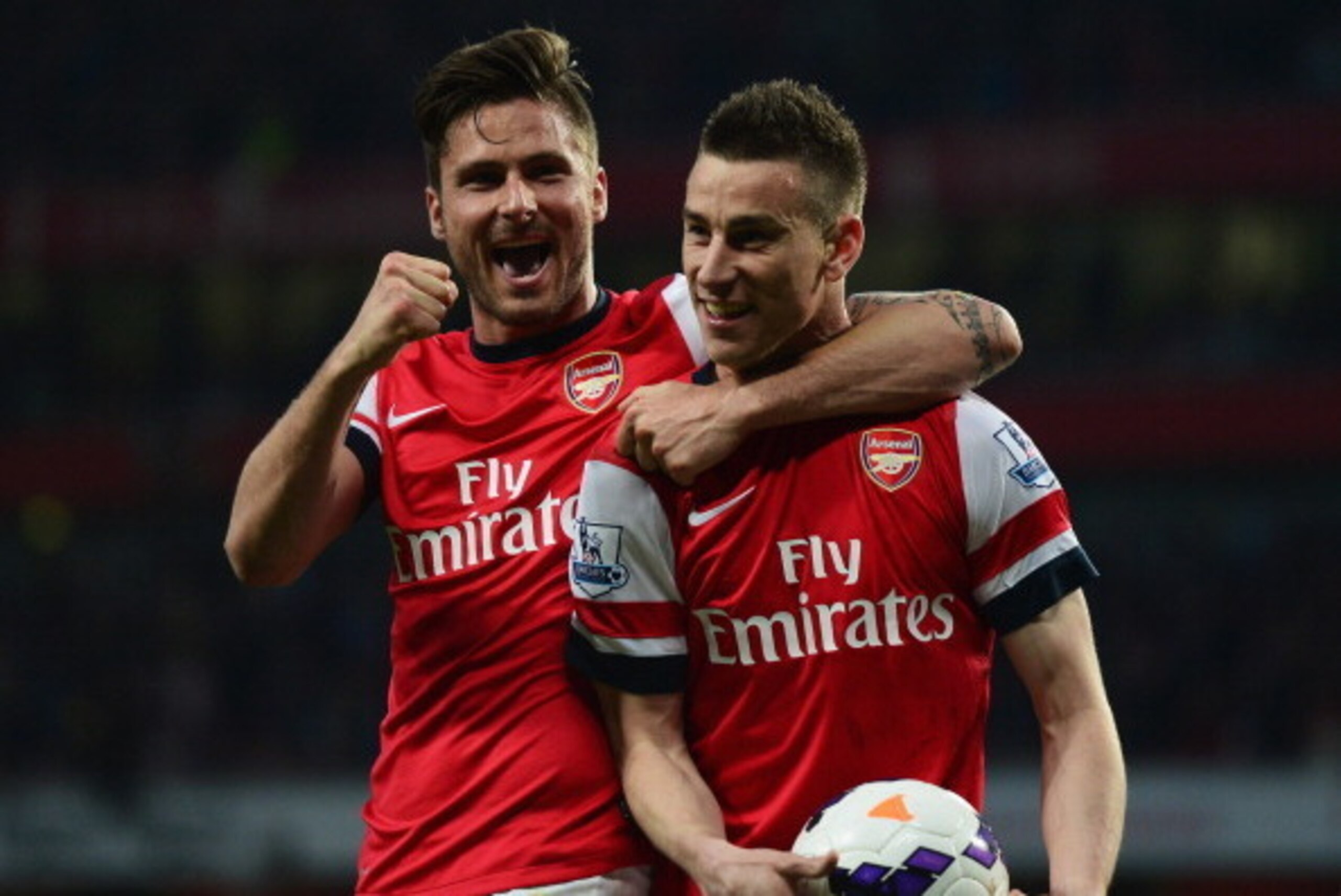 LONDON, ENGLAND - APRIL 28:  Laurent Koscielny of Arsenal celebrates wth Olivier Giroud (L) as he scores their first goal during the Barclays Premier League match between Arsenal and Newcastle United at Emirates Stadium on April 28, 2014 in London, Englan