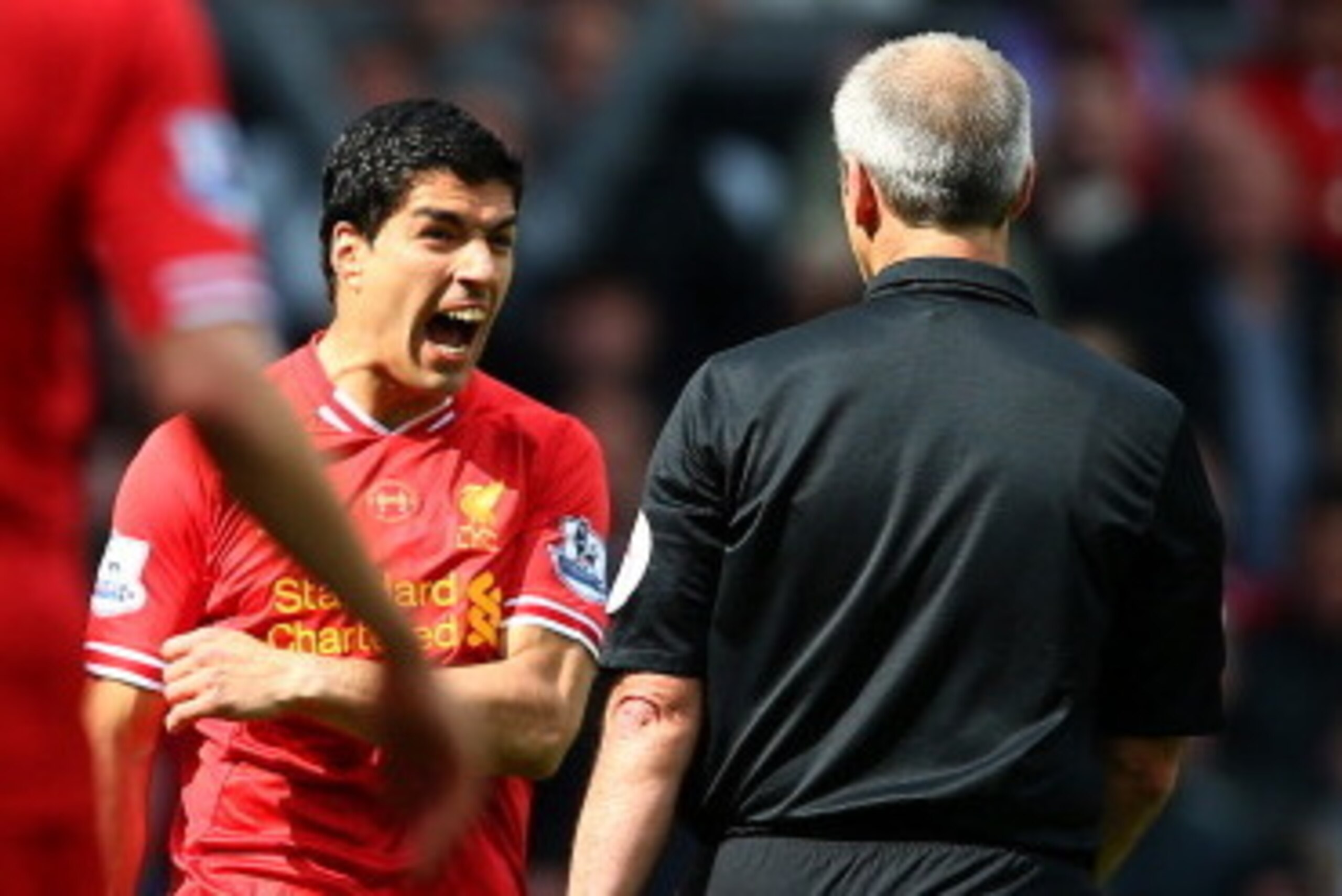 LIVERPOOL, ENGLAND - APRIL 27: Luis Suarez of Liverpool makes a point to the referee Mr M Atkinson  during the Barclays Premier League match between Liverpool and Chelsea at Anfield on April 27, 2014 in Liverpool, England.  (Photo by Clive Brunskill/Getty
