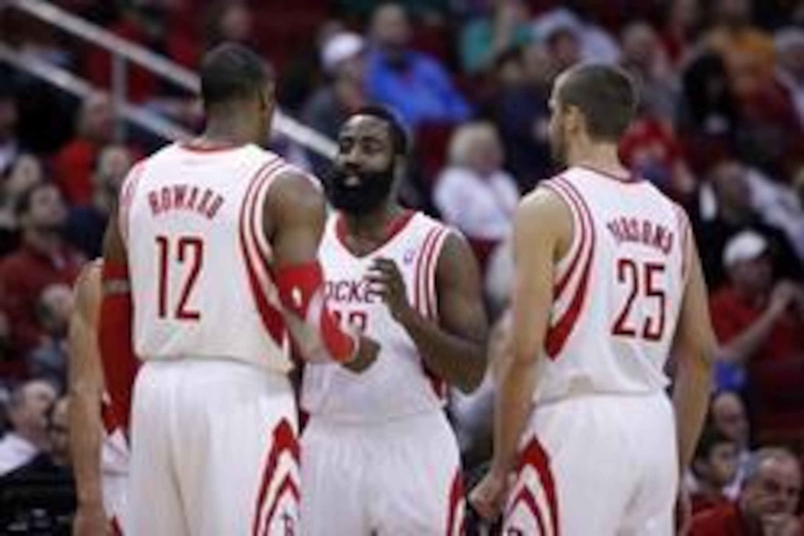 Jan 16, 2014; Houston, TX, USA; Houston Rockets shooting guard James Harden (13) speaks with power forward Dwight Howard (12) and small forward Chandler Parsons (25) during the first quarter against the Oklahoma City Thunder at Toyota Center. Mandatory Cr