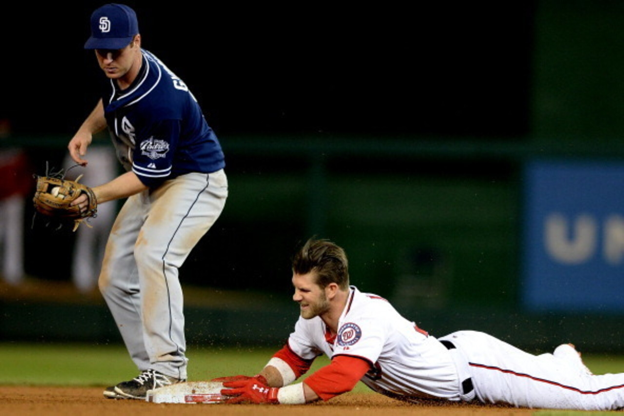 WASHINGTON, DC - APRIL 24:  Bryce Harper #34 of the Washington Nationals slides safely into second base against the San Diego Padres in the twelfth inning at Nationals Park on April 24, 2014 in Washington, DC. The San Diego Padres won, 4-3, in twelve inni