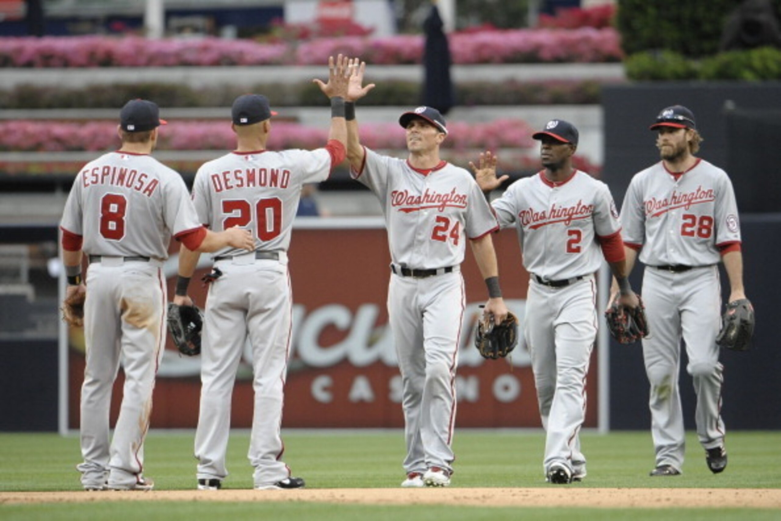 SAN DIEGO, CA - APRIL 25:  Washington Nationals players high five after the Nationals beat the San Diego Padres 7-2 in  a baseball game at Petco Park on April 25, 2012 in San Diego, California.  (Photo by Denis Poroy/Getty Images)