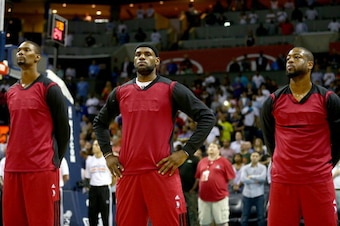 CHARLOTTE, NC - APRIL 28:  Chris Bosh #1 of the Miami Heat stands alongside teammates LeBron James #6 and Dwyane Wade #3 before playing the Charlotte Bobcats in Game Four of the Eastern Conference Quarterfinals during the 2014 NBA Playoffs at Time Warner 