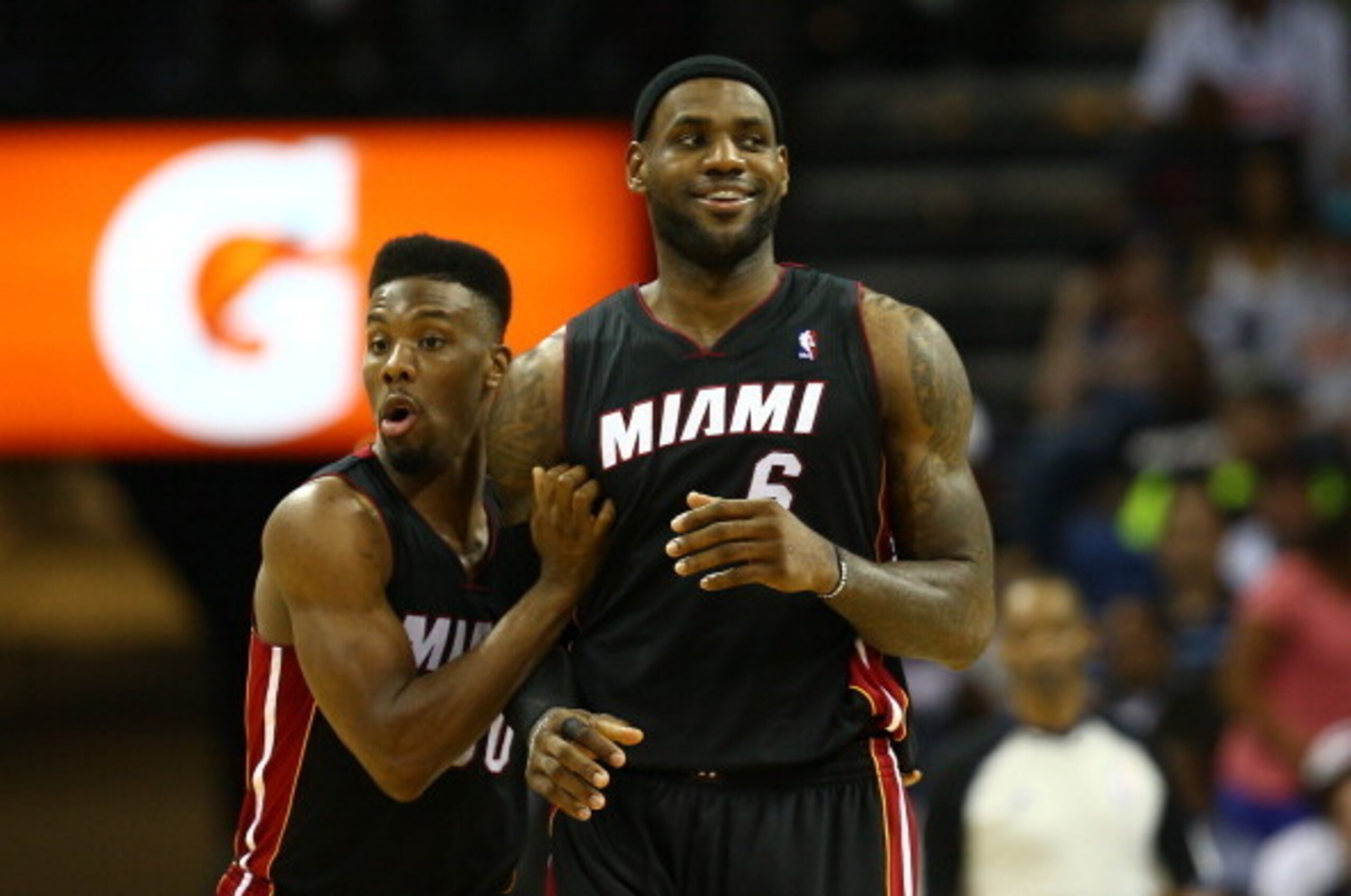 CHARLOTTE, NC - APRIL 28:  LeBron James #6 and teammate Norris Cole #30 of the Miami Heat reacts after a play on their way to defeating the Charlotte Bobcats 109-98 in Game Four of the Eastern Conference Quarterfinals during the 2014 NBA Playoffs at Time 