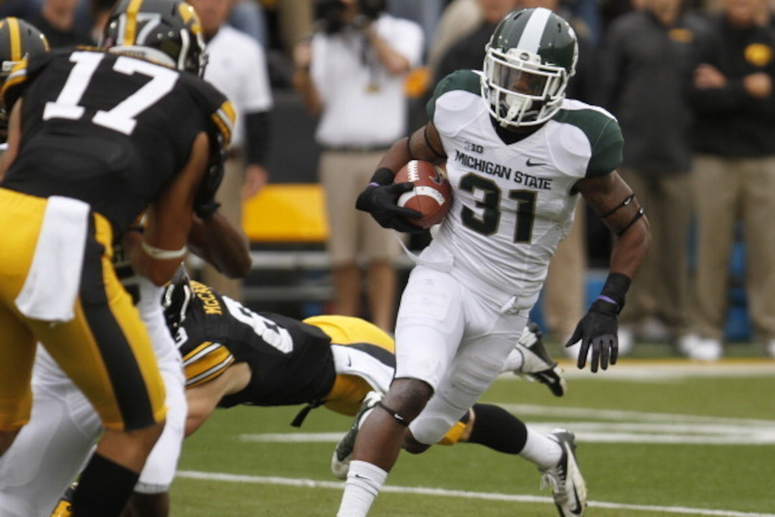 IOWA CITY, IOWA - OCTOBER 5:  Cornerback Darqueze Dennard #31 of the Michigan State Spartans runs back an interception up field during the first quarter in front of wide receiver Riley McCarron #83 of the Iowa Hawkeyes on October 5, 2013 at Kinnick Stadiu