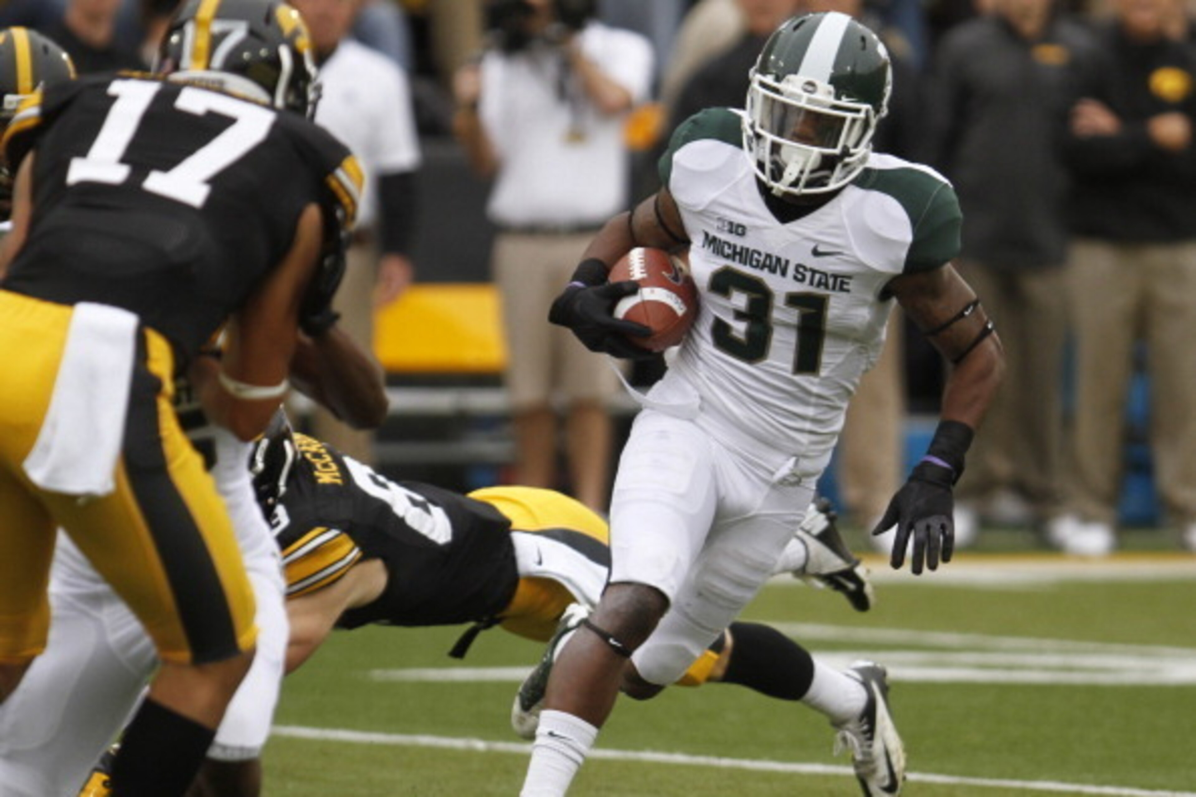 IOWA CITY, IOWA - OCTOBER 5:  Cornerback Darqueze Dennard #31 of the Michigan State Spartans runs back an interception up field during the first quarter in front of wide receiver Riley McCarron #83 of the Iowa Hawkeyes on October 5, 2013 at Kinnick Stadiu