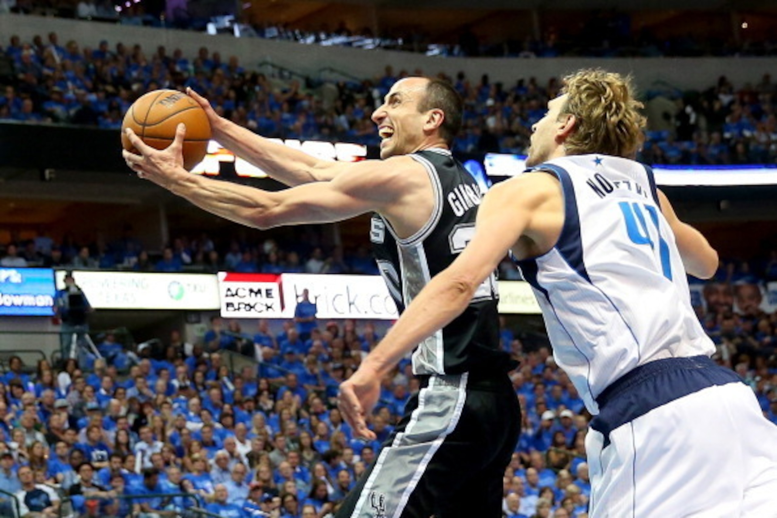 DALLAS, TX - APRIL 28:  Manu Ginobili #20 of the San Antonio Spurs takes a shot against Dirk Nowitzki #41 of the Dallas Mavericks in Game Four of the Western Conference Quarterfinals during the 2014 NBA Playoffs at American Airlines Center on April 28, 20