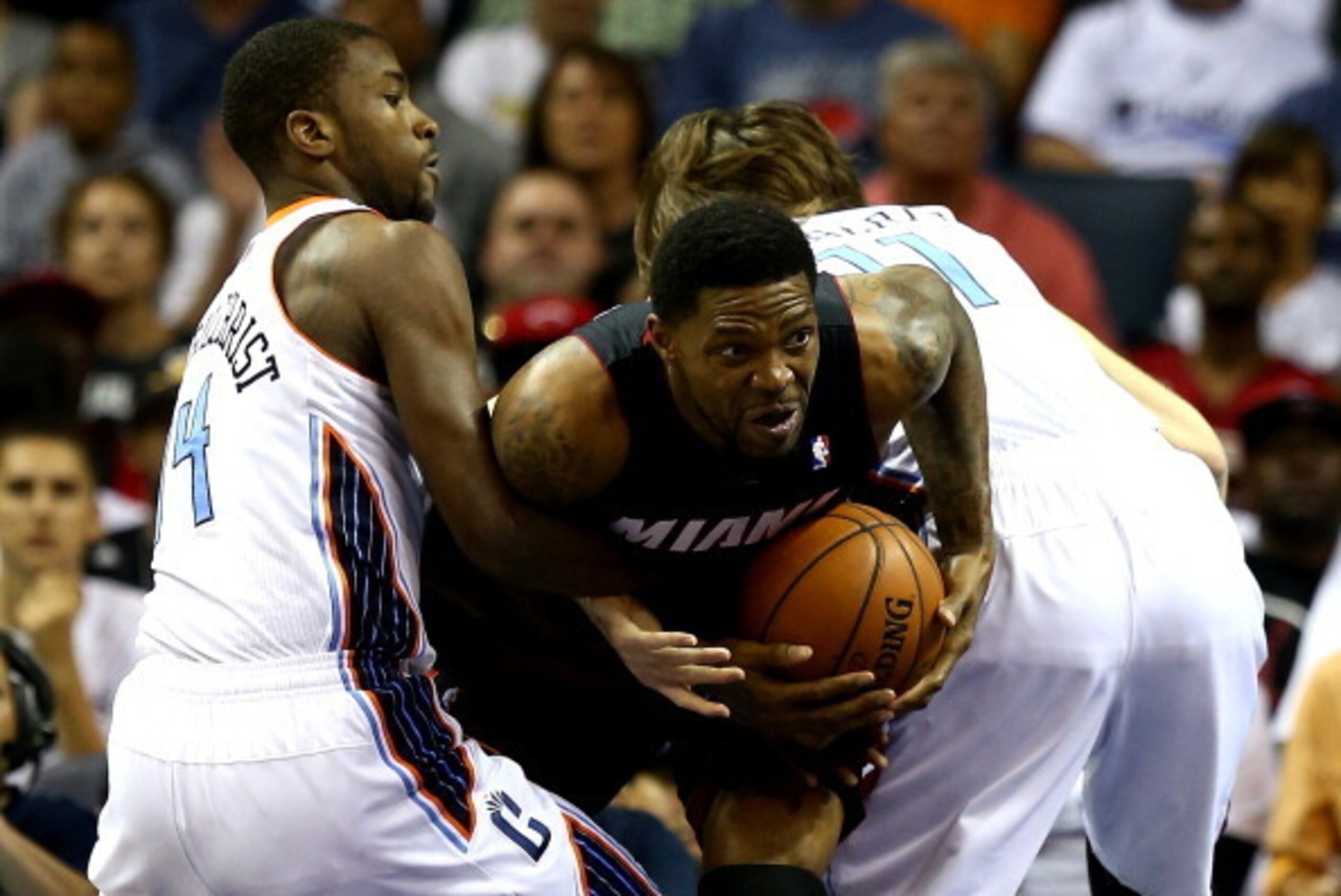 CHARLOTTE, NC - APRIL 28: Michael Kidd-Gilchrist #14 and teammate Josh McRoberts #11 of the Charlotte Bobcats try to trap Udonis Haslem #40 of the Miami Heat in Game Four of the Eastern Conference Quarterfinals during the 2014 NBA Playoffs at Time Warner CHARLOTTE, NC - APRIL 28: Michael Kidd-Gilchrist #14 and teammate Josh McRoberts #11 of the Charlotte Bobcats try to trap Udonis Haslem #40 of the Miami Heat in Game Four of the Eastern Conference Quarterfinals during the 2014 NBA Playoffs at Time Warner