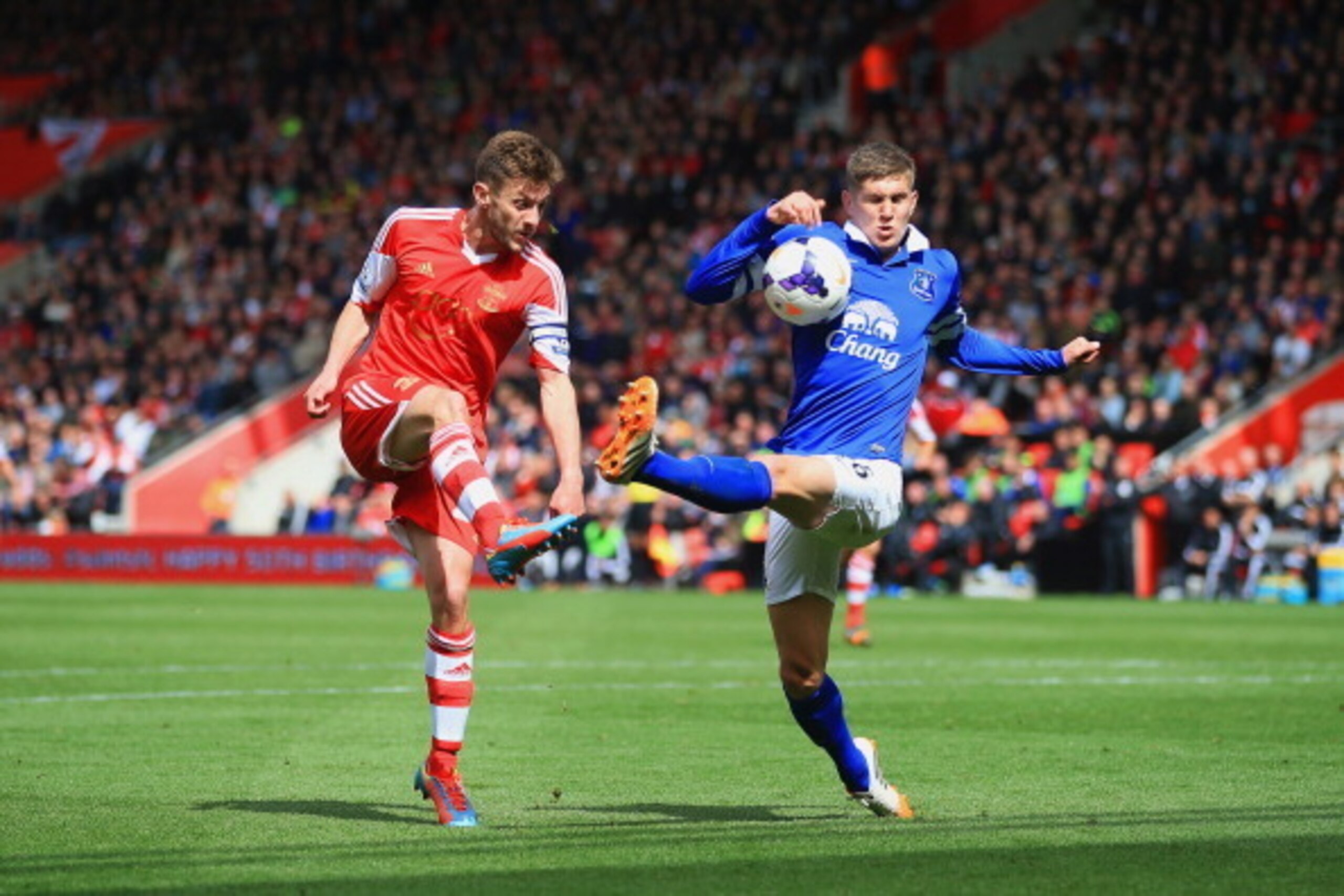 SOUTHAMPTON, ENGLAND - APRIL 26:  Adam Lallana of Southampton crosses the ball under pressure from John Stones of Everton during the Barclays Premier League match between Southampton and Everton at St Mary's Stadium on April 26, 2014 in Southampton, Engla