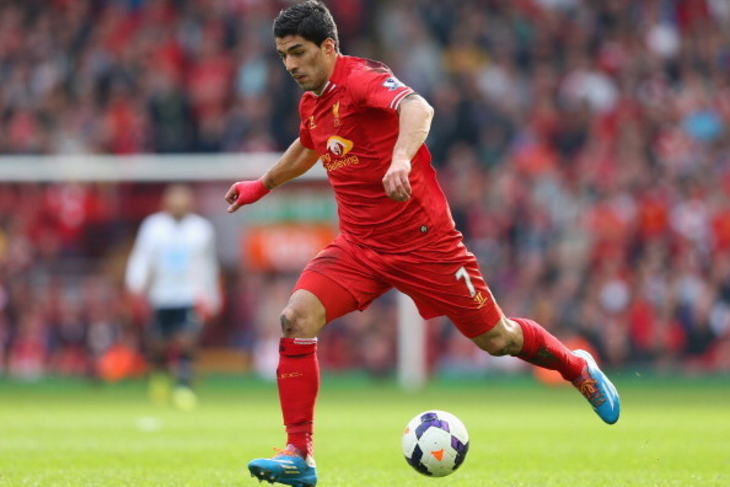 LIVERPOOL, ENGLAND - MARCH 30:  Luis Suarez of Liverpool in action during the Barclays Premier League match between Liverpool and Tottenham Hotspur at Anfield on March 30, 2014 in Liverpool, England.  (Photo by Alex Livesey/Getty Images)