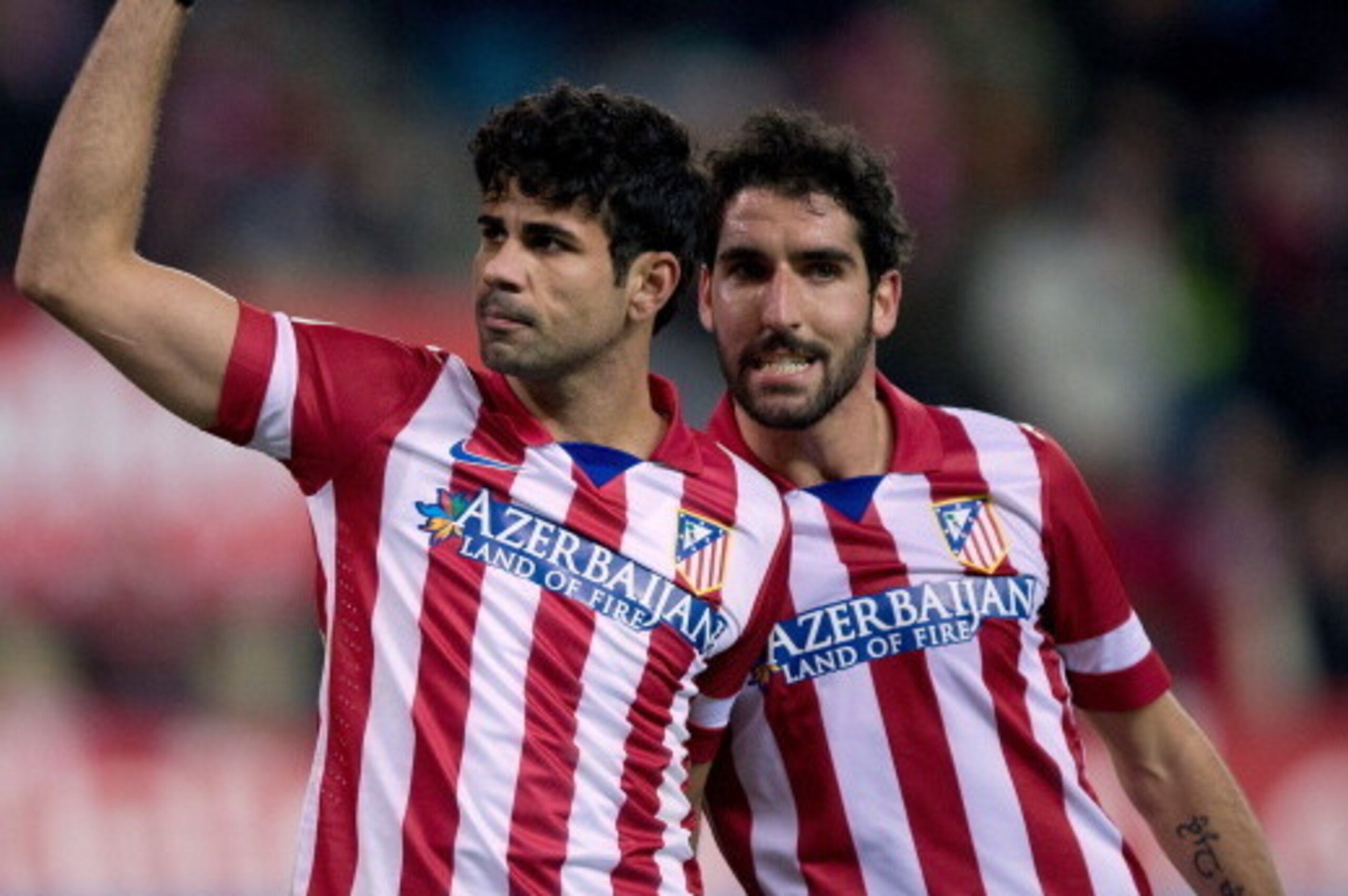 MADRID, SPAIN - DECEMBER 21:  Diego Costa (L) of Atletico de Madrid celebrates scoring their third goal with teammate Raul Garcia (R) during the La Liga match between Club Atletico de Madrid and Levante UD at Vicente Calderon Stadium on December 21, 2013