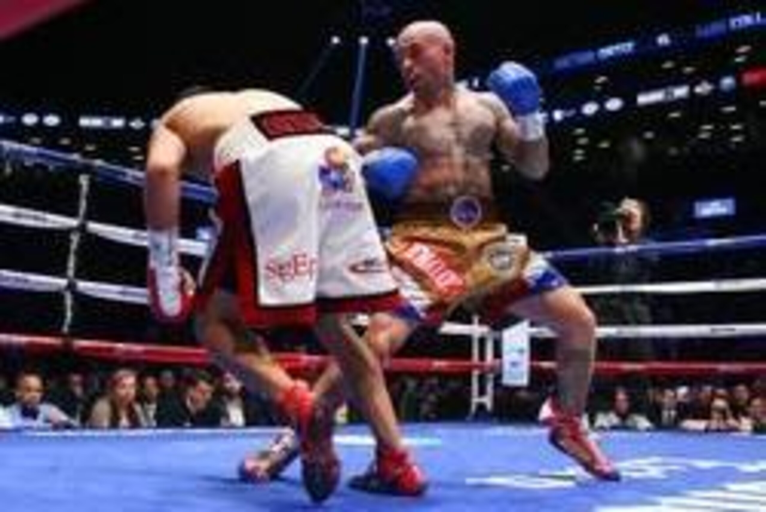 Jan 30, 2014; Brooklyn, NY, USA; Victor Ortiz (White/Red trunks) falls to the canvas after a right hook from Luis Collazo (Tan/Blue/Red trunks) during their bout at Barclays Center. Collazo won via 2nd round KO. Mandatory Credit: Ed Mulholland-USA TODAY Jan 30, 2014; Brooklyn, NY, USA; Victor Ortiz (White/Red trunks) falls to the canvas after a right hook from Luis Collazo (Tan/Blue/Red trunks) during their bout at Barclays Center. Collazo won via 2nd round KO. Mandatory Credit: Ed Mulholland-USA TODAY