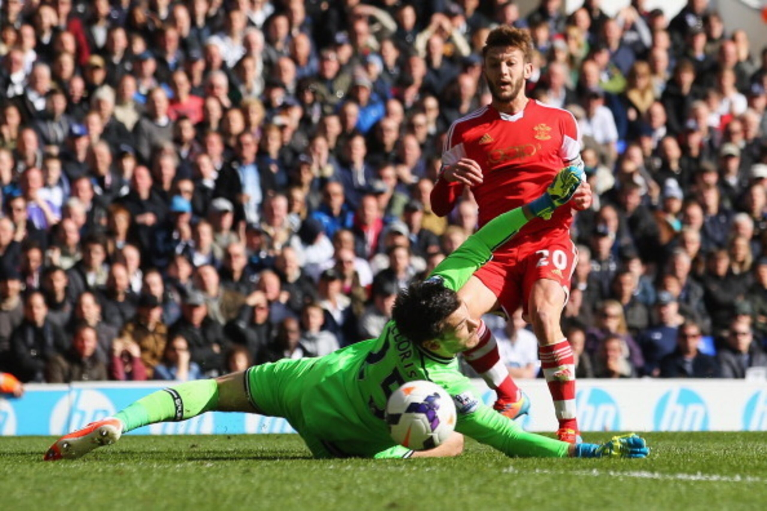 LONDON, ENGLAND - MARCH 23:  Adam Lallana of Southampton scores his team's second goal past Hugo Lloris of Tottenham Hotspur during the Barclays Premier League match between Tottenham Hotspur and Southampton at White Hart Lane on March 23, 2014 in London,