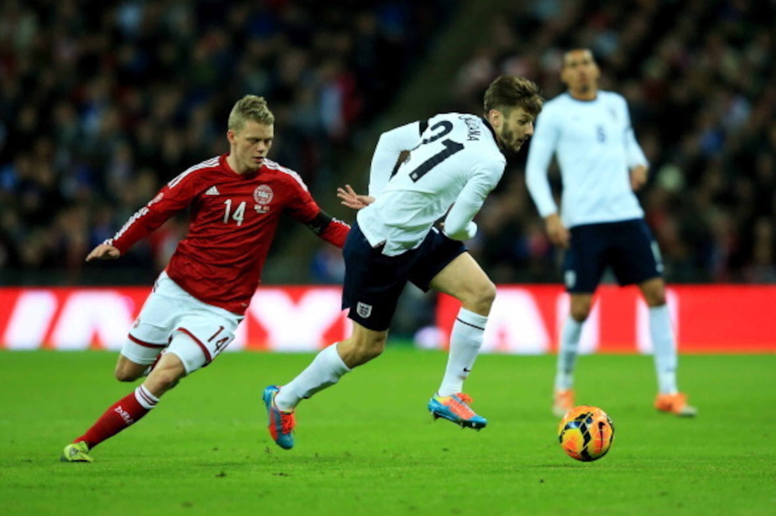 LONDON, ENGLAND - MARCH 05:  Adam Lallana of England evades Kasper Kusk of Denmark during the International Friendly match between England and Denmark at Wembley Stadium on March 5, 2014 in London, England.  (Photo by Richard Heathcote/Getty Images)