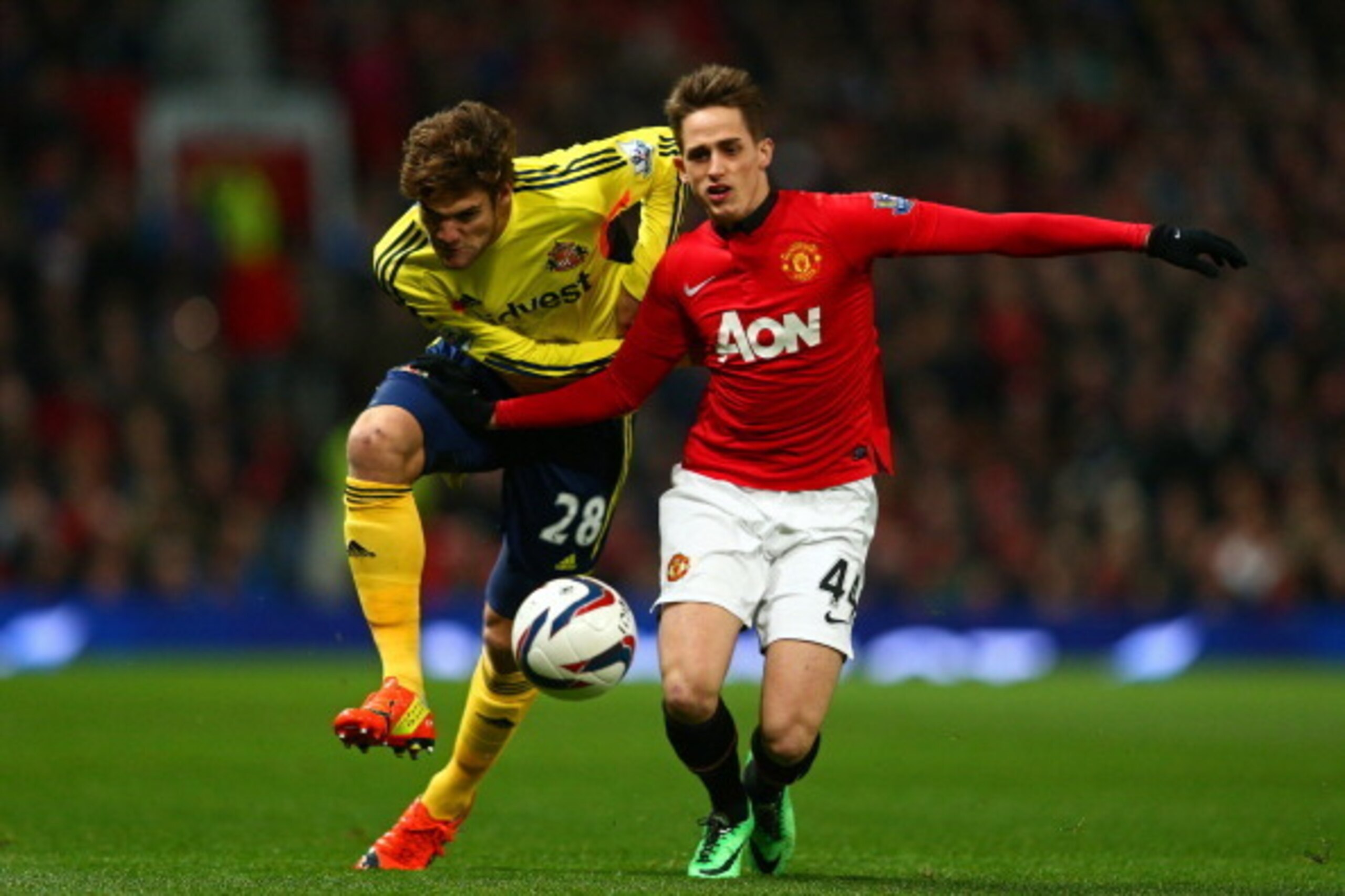 MANCHESTER, ENGLAND - JANUARY 22:  Marcos Alonso of Sunderland and Adnan Januzaj of Manchester United battle for possession during the Capital One Cup semi final, second leg match between Manchester United and Sunderland at Old Trafford on January 22, 201