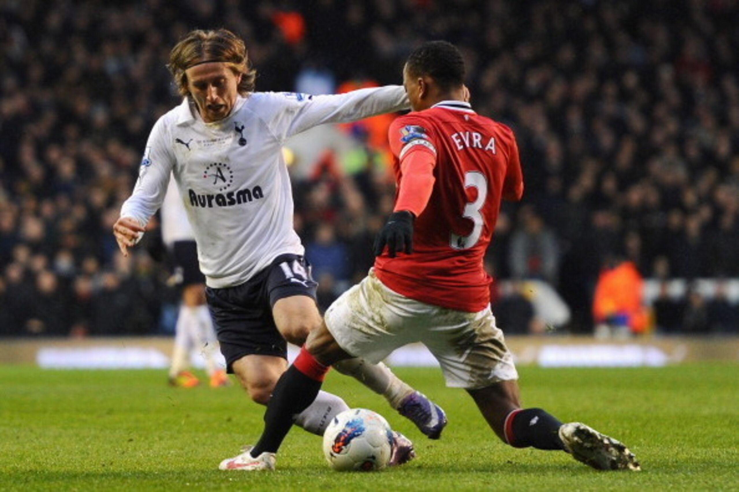 LONDON, ENGLAND - MARCH 04:  Luka Modric of Tottenham Hotspur and tackled by Patrice Evra of Manchester United during the Barclays Premier League match between Tottenham Hotspur and Manchester United at White Hart Lane on March 4, 2012 in London, England.