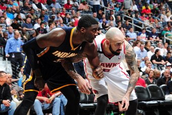 ATLANTA, GA - APRIL 24:  Roy Hibbert #55 of the Indiana Pacers fights for position against Pero Antic #6 of the Atlanta Hawks during Game Three of the Eastern Conference Quarterfinals on April 24, 2014 at Philips Arena in Atlanta, Georgia.  NOTE TO USER: 