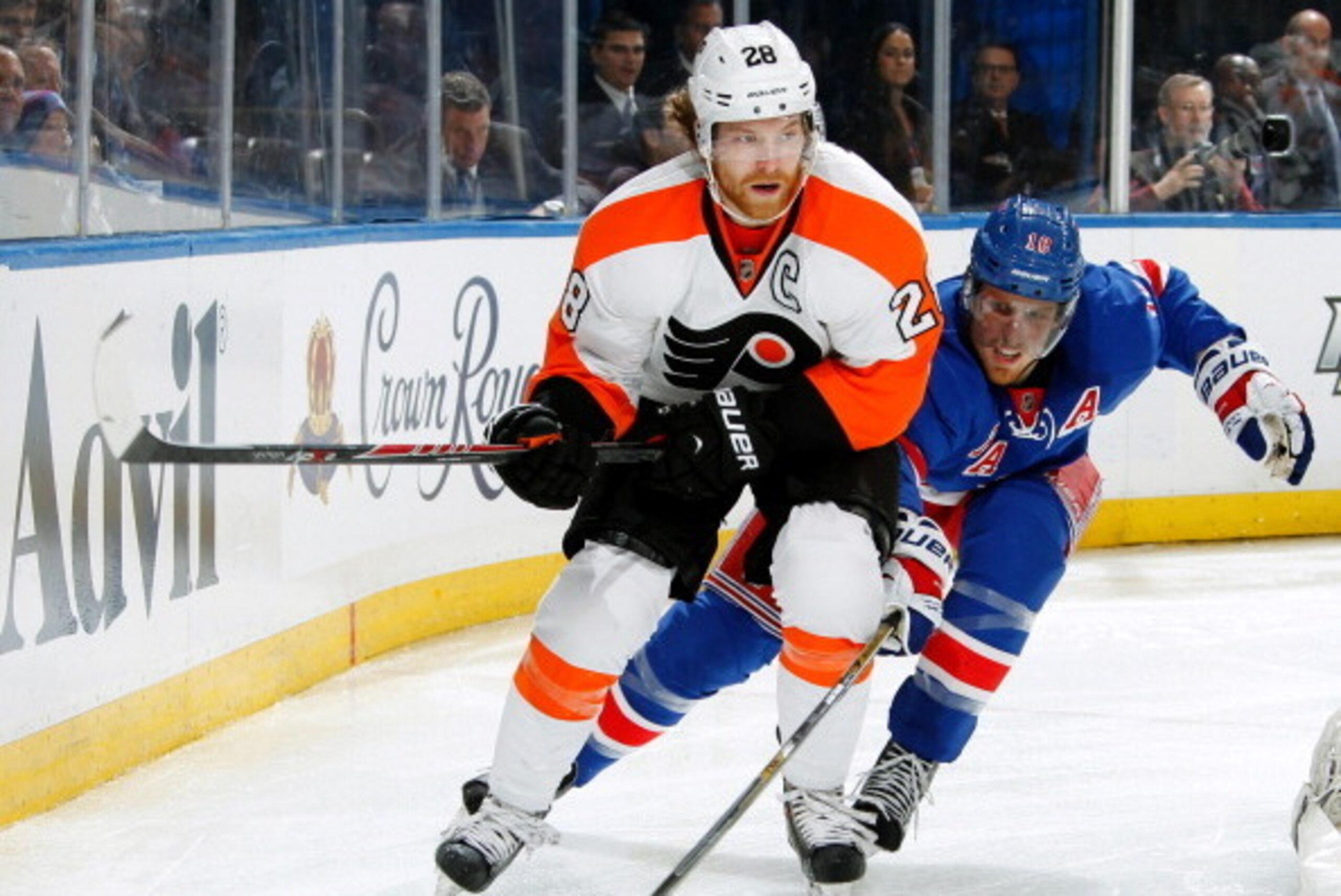 NEW YORK, NY - APRIL 27:  Marc Staal #18 of the New York Rangers attempts to poke the puck away from Claude Giroux #28 of the Philadelphia Flyers in Game Five of the First Round of the 2014 Stanley Cup Playoffs at Madison Square Garden on April 27, 2014 i