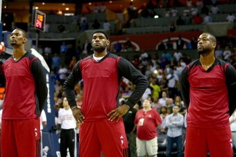 CHARLOTTE, NC - APRIL 28:  Chris Bosh #1 of the Miami Heat stands alongside teammates LeBron James #6 and Dwyane Wade #3 while wearing inside out warm up jerseys before playing the Charlotte Bobcats in Game Four of the Eastern Conference Quarterfinals dur