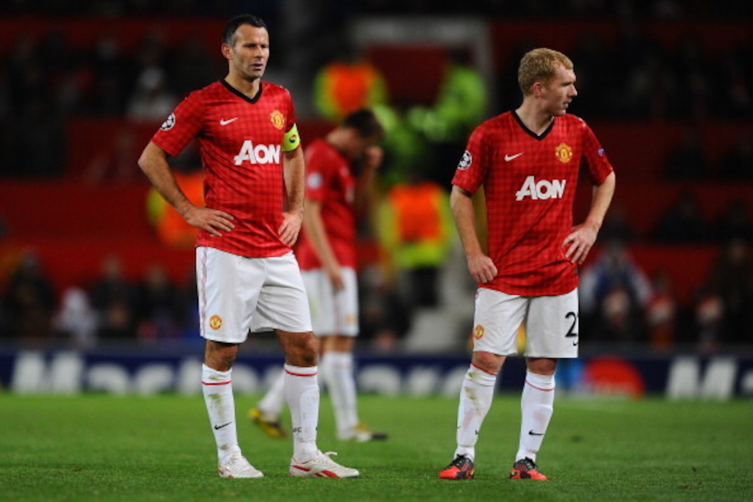 MANCHESTER, ENGLAND - DECEMBER 05:  (L-R)  Ryan Giggs and Paul Scholes of Manchester United look on dejectedly during the UEFA Champions League Group H match between Manchester United and CFR 1907 Cluj at Old Trafford on December 5, 2012 in Manchester, En