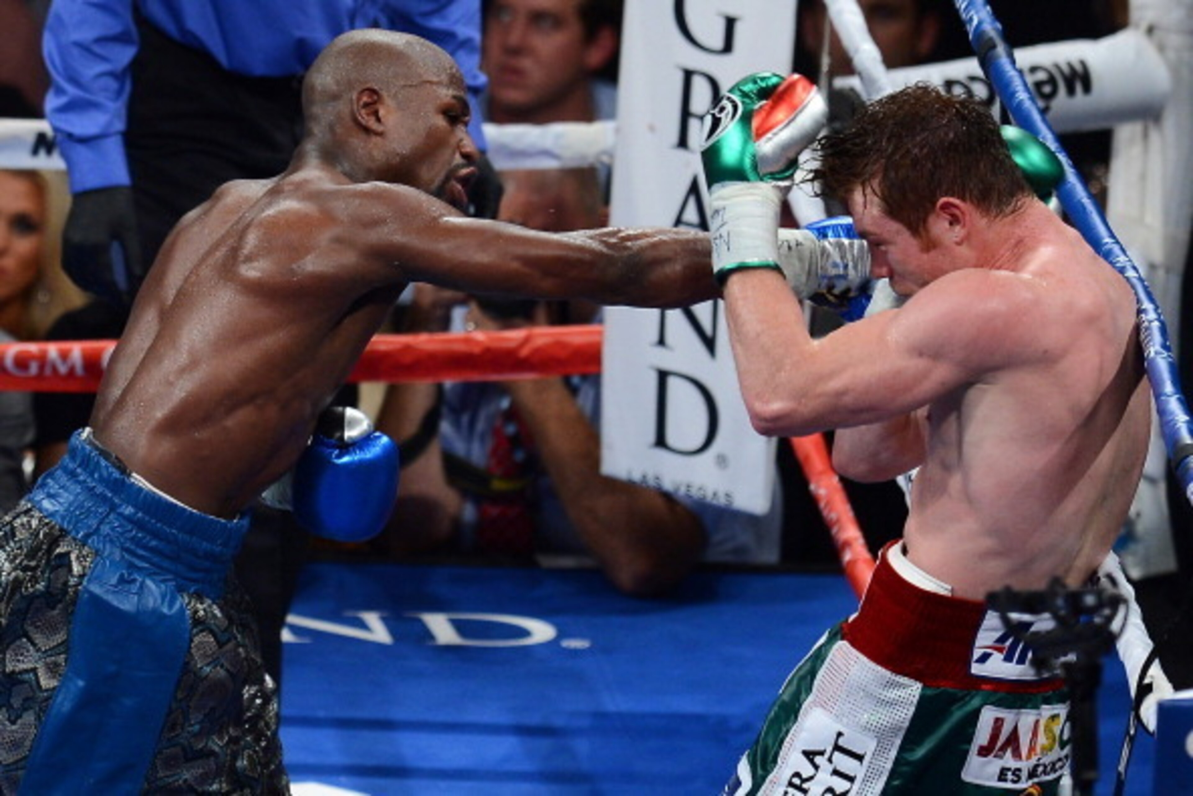 LAS VEGAS, NV - SEPTEMBER 14: (L-R) Floyd Mayweather Jr. throws a right at Canelo Alvarez during their WBC/WBA 154-pound title fight at the MGM Grand Garden Arena on September 14, 2013 in Las Vegas, Nevada. (Photo by Ethan Miller/Getty Images) LAS VEGAS, NV - SEPTEMBER 14: (L-R) Floyd Mayweather Jr. throws a right at Canelo Alvarez during their WBC/WBA 154-pound title fight at the MGM Grand Garden Arena on September 14, 2013 in Las Vegas, Nevada. (Photo by Ethan Miller/Getty Images)