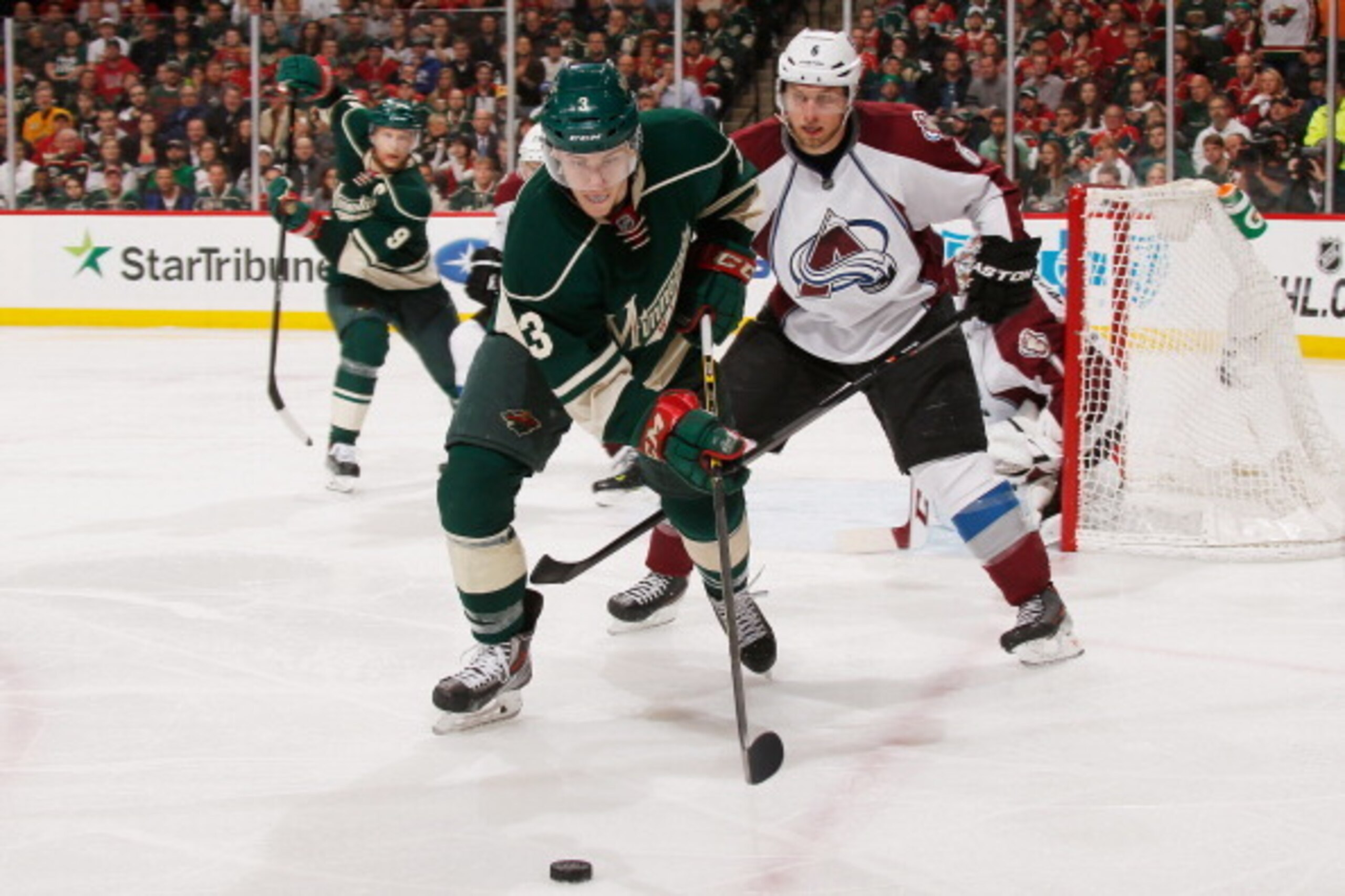 ST. PAUL, MN - APRIL 28:  Charlie Coyle #3 of the Minnesota Wild skates with the puck while Erik Johnson #6 of the Colorado Avalanche defends during Game Six of the First Round of the 2014 Stanley Cup Playoffs on April 28, 2014 at the Xcel Energy Center i