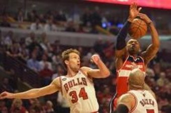 Apr 29, 2014; Chicago, IL, USA; Washington Wizards guard Bradley Beal (3) shoots the ball as Chicago Bulls forward Mike Dunleavy (34) and forward Carlos Boozer (5) defend in the first half in game five of the first round of the 2014 NBA Playoffs at United Apr 29, 2014; Chicago, IL, USA; Washington Wizards guard Bradley Beal (3) shoots the ball as Chicago Bulls forward Mike Dunleavy (34) and forward Carlos Boozer (5) defend in the first half in game five of the first round of the 2014 NBA Playoffs at United