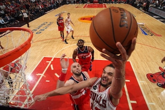 CHICAGO, IL - APRIL 29: Joakim Noah #13 of the Chicago Bulls shoots against Marcin Gortat #4 of the Washington Wizards in Game 5 of the Eastern Conference Quarterfinals in the 2014 NBA Playoffs on April 29, 2014 at the United Center in Chicago, Illinois. CHICAGO, IL - APRIL 29: Joakim Noah #13 of the Chicago Bulls shoots against Marcin Gortat #4 of the Washington Wizards in Game 5 of the Eastern Conference Quarterfinals in the 2014 NBA Playoffs on April 29, 2014 at the United Center in Chicago, Illinois.