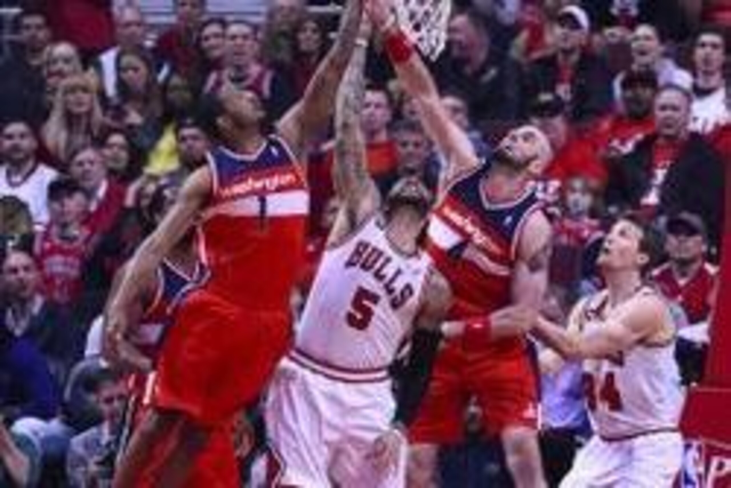 Apr 29, 2014; Chicago, IL, USA; Washington Wizards forward Trevor Ariza (1), center Marcin Gortat (4), and Chicago Bulls forward Carlos Boozer (5) battle for a rebound during the first quarter in game five of the first round of the 2014 NBA Playoffs at Un Apr 29, 2014; Chicago, IL, USA; Washington Wizards forward Trevor Ariza (1), center Marcin Gortat (4), and Chicago Bulls forward Carlos Boozer (5) battle for a rebound during the first quarter in game five of the first round of the 2014 NBA Playoffs at Un