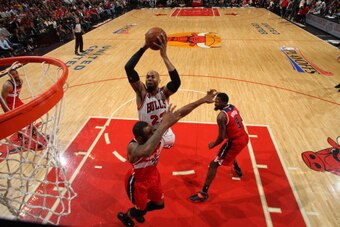 CHICAGO, IL - APRIL 29: Taj Gibson #22 of the Chicago Bulls shoots against Trevor Booker #35 and Martell Webster #9 of the Washington Wizards in Game 5 of the Eastern Conference Quarterfinals in the 2014 NBA Playoffs on April 29, 2014 at the United Center CHICAGO, IL - APRIL 29: Taj Gibson #22 of the Chicago Bulls shoots against Trevor Booker #35 and Martell Webster #9 of the Washington Wizards in Game 5 of the Eastern Conference Quarterfinals in the 2014 NBA Playoffs on April 29, 2014 at the United Center