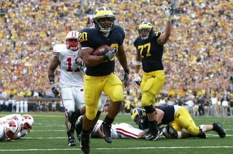 ANN ARBOR, MI - SEPTEMBER 23:  Mike Hart #20 of the Michigan Wolverines scores a touchdown in the 2nd half against DeAndre Levy #11 and other defenders of the Wisconsin Badgers as teammate Jake Long #77 celebrates on September 23, 2006 at Michigan Stadium
