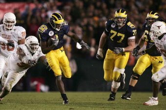 PASADENA, CA - JANUARY 01:  Braylon Edwards #1 of the Michigan Wolverines avoids a tackle as he runs with the ball against the Texas Longhorns in the 91st Rose Bowl Game at the Rose Bowl on January 1, 2005 in Pasadena, California.    (Photo by Jed Jacobso