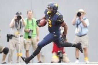 Aug 31, 2013; Morgantown, WV, USA; West Virginia Mountaineers running back Charles Sims (3) carries the ball into the end zone for a touchdown against the William & Mary Tribe during the first quarter at Milan Puskar Stadium. Mandatory Credit: Charles LeC