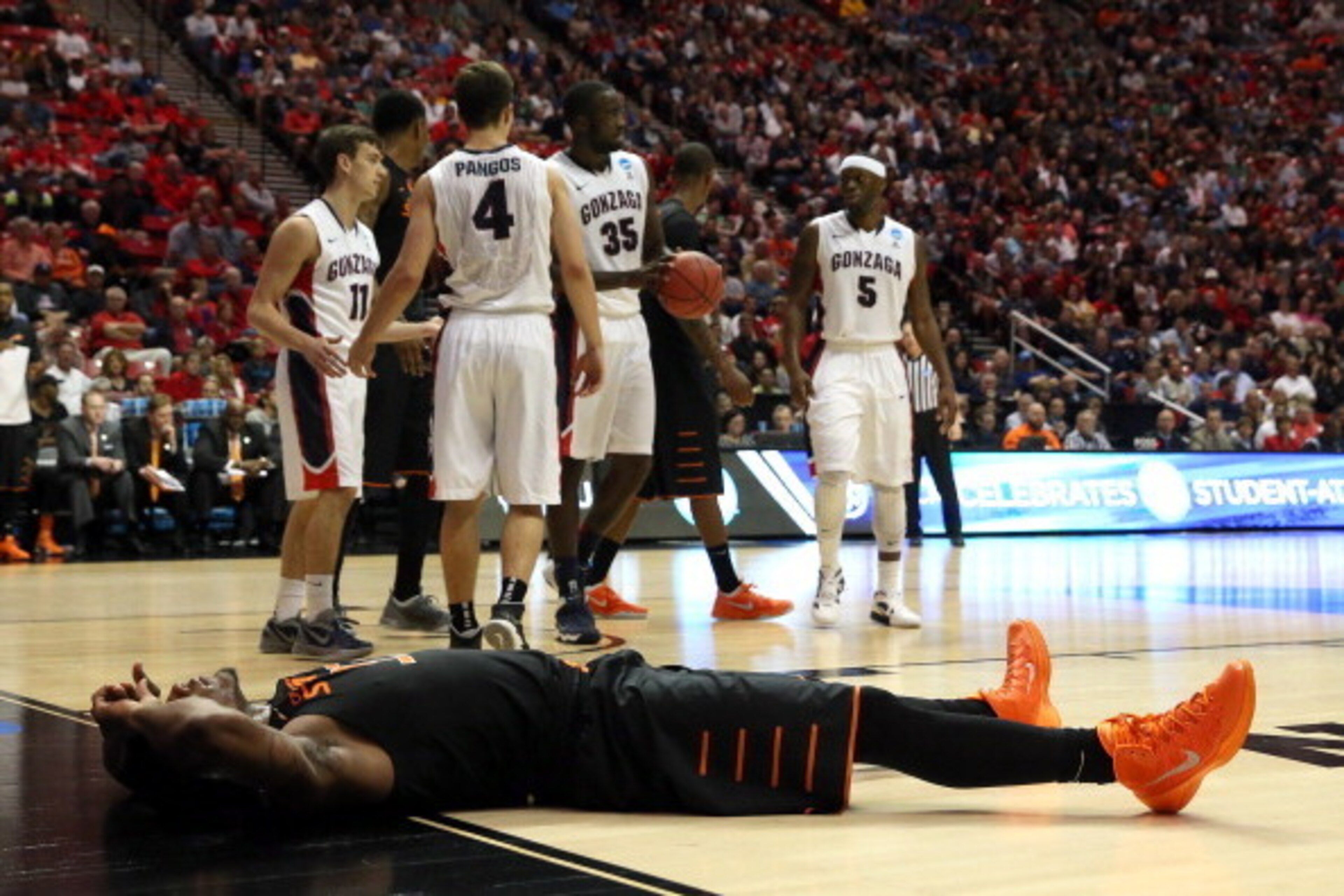 SAN DIEGO, CA - MARCH 21:  Marcus Smart #33 of the Oklahoma State Cowboys lies on the floor after being foule by the Gonzaga Bulldogs during the second round of the 2014 NCAA Men's Basketball Tournament at Viejas Arena on March 21, 2014 in San Diego, Cali