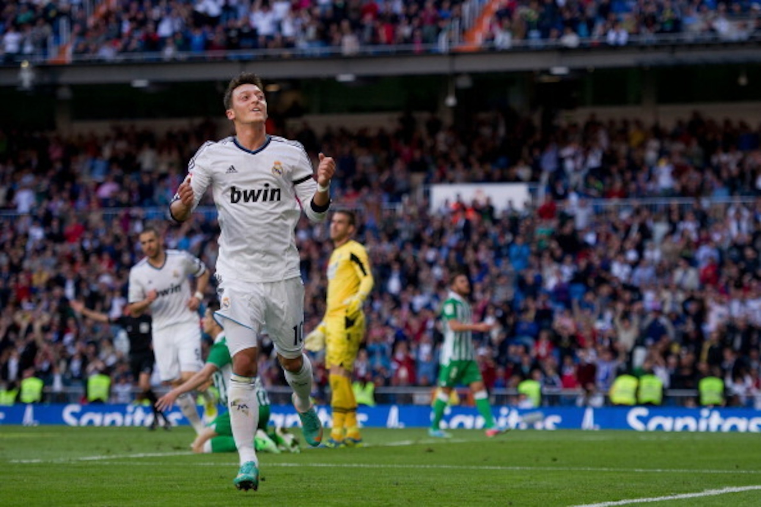 MADRID, SPAIN - APRIL 20:  Mesut Ozil of Real Madrid CF celebrates scoring their opening goal during the La Liga match between Real Madrid CF and Real Betis Balompie at Santiago Bernabeu Stadium on April 20, 2013 in Madrid, Spain.  (Photo by Gonzalo Arroy