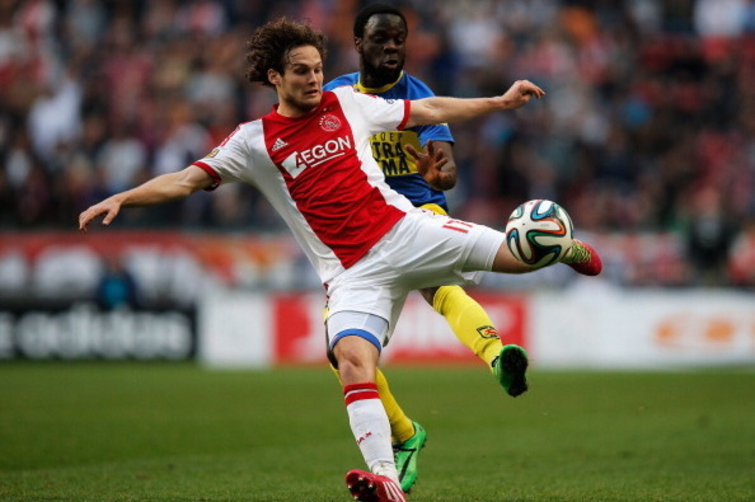 AMSTERDAM, NETHERLANDS - MARCH 09:  Daley Blind of Ajax clears the ball away from Elvis Manu of Cambuur during the Eredivisie match between Ajax Amsterdam and SC Cambuur Leeuwarden at Amsterdam Arena on March 9, 2014 in Amsterdam, Netherlands.  (Photo by 
